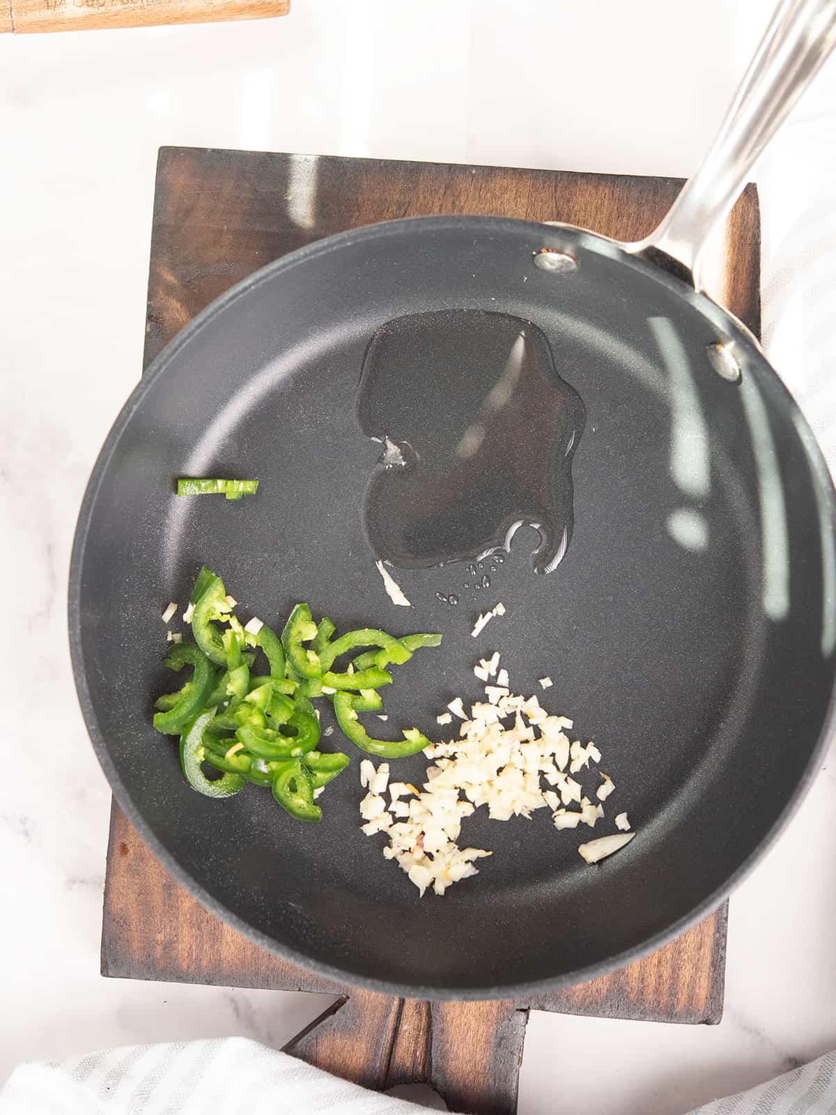 pan with minced garlic and jalapeno slices 