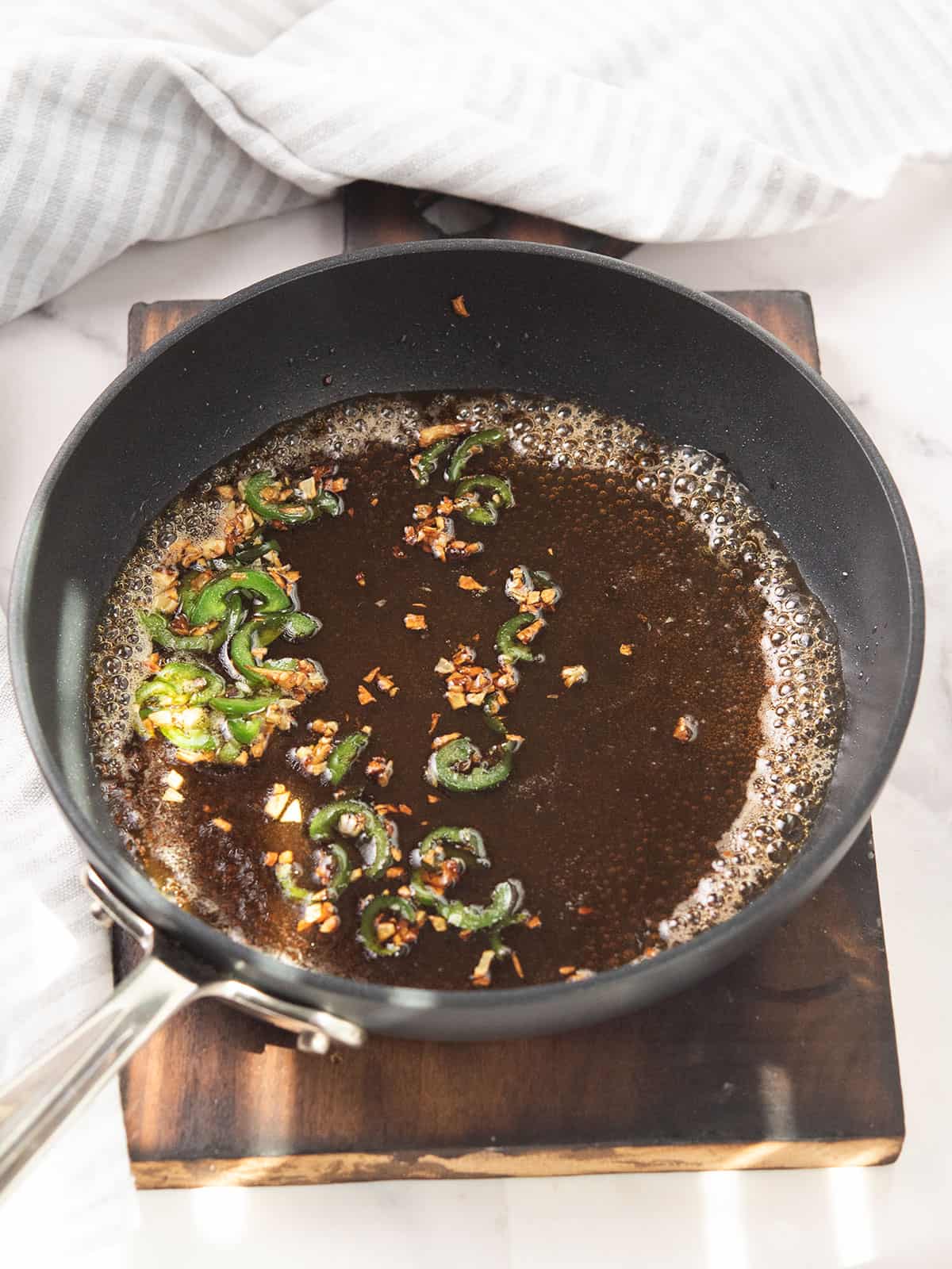 making the jalapeno honey sauce step 2, adding all the ingredients to the pan