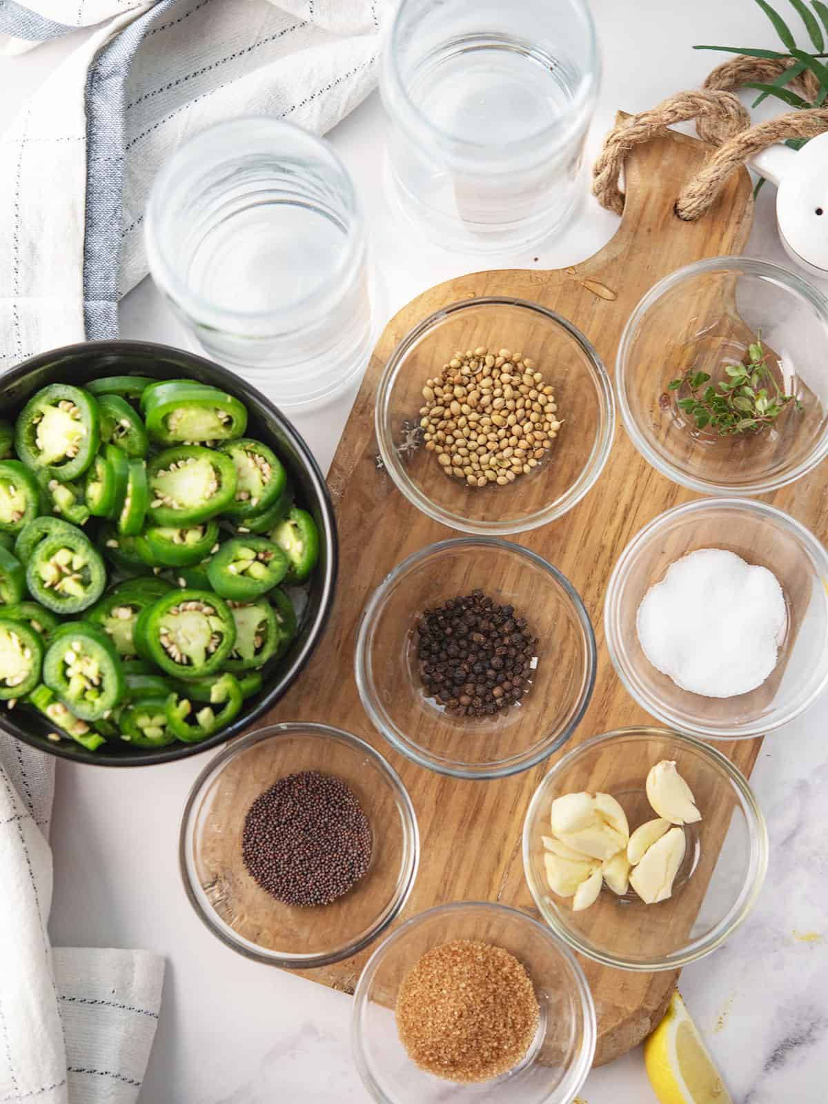 ingredients for the pickled jalapenos arranged in the kitchen counter