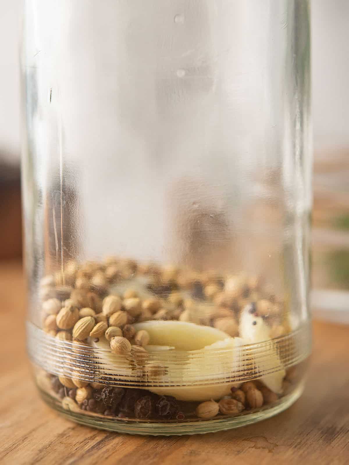 the spices are in the clear glass jar for making pickled jalapenos