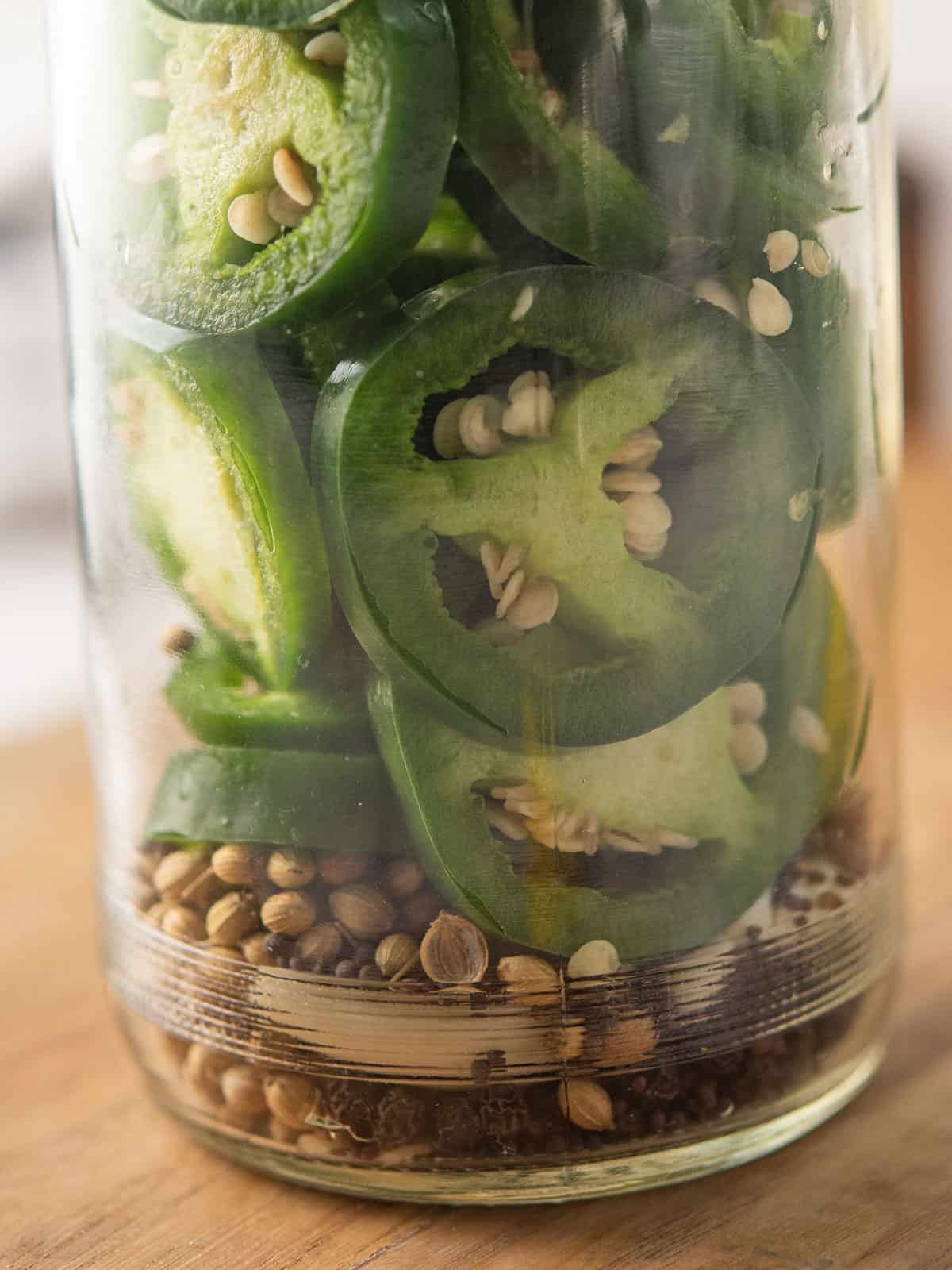 brine is added to the clear jar of pickled jalapeno
