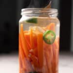 spicy pickled carrots in a clear glass jar