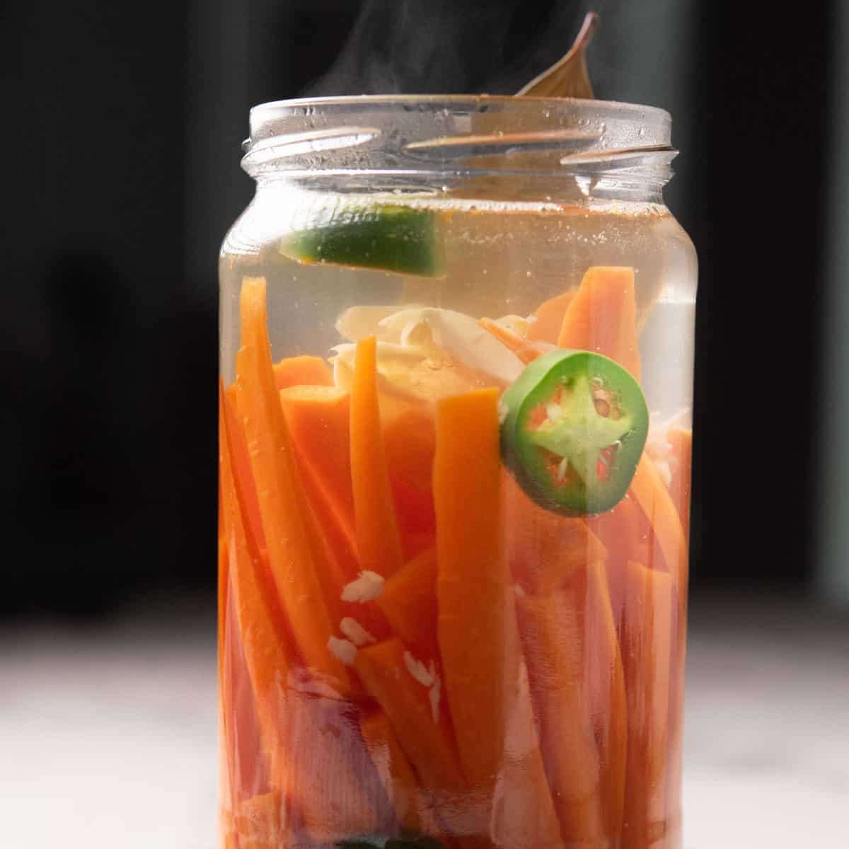 spicy pickled carrots in a clear glass jar