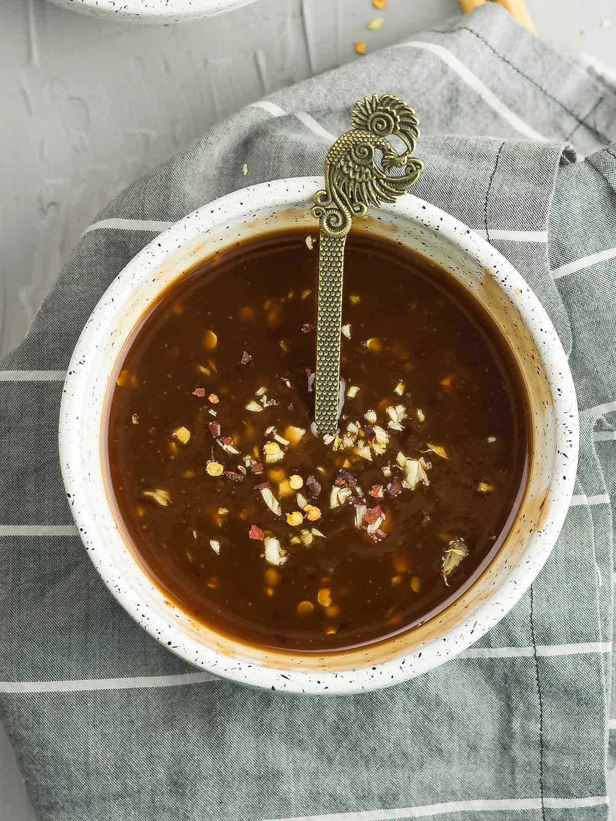 Bowl of Asian zing sauce with kitchen towel
