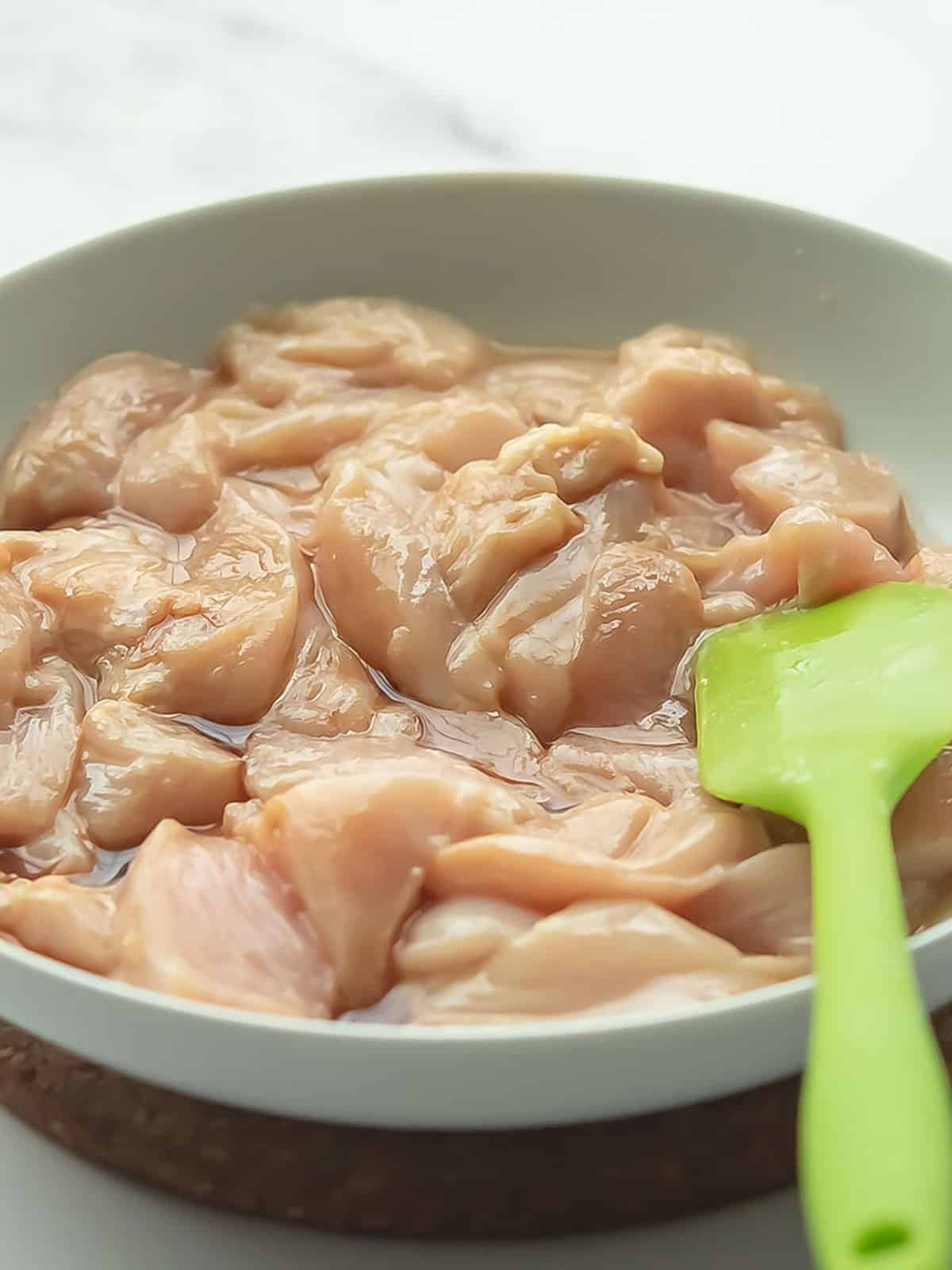 Cut chicken breast into bite-sized cubes for Jalapeno Chicken preparation