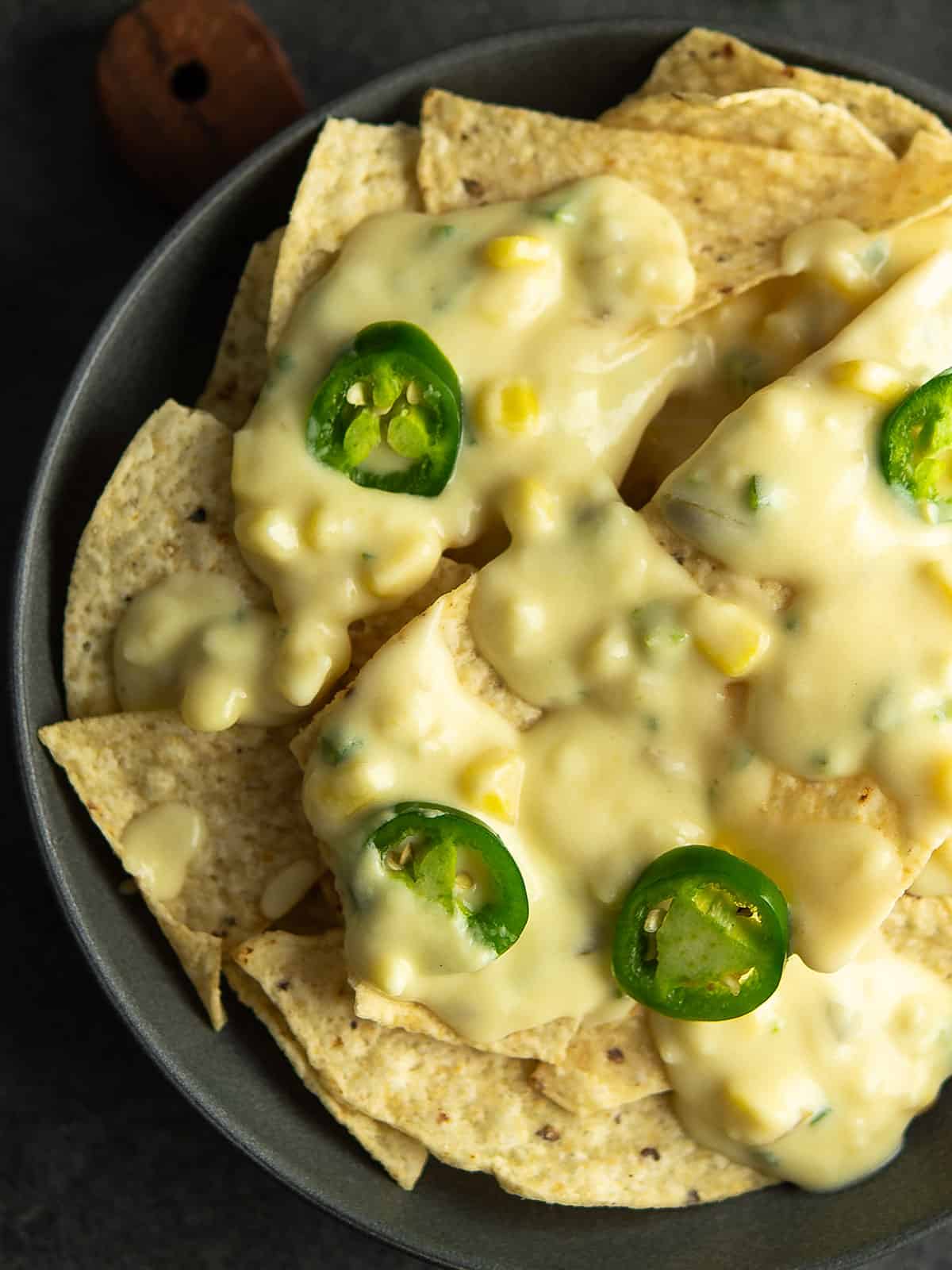 Cheesy jalapeno nachos served on a colorful plate, perfect for sharing.