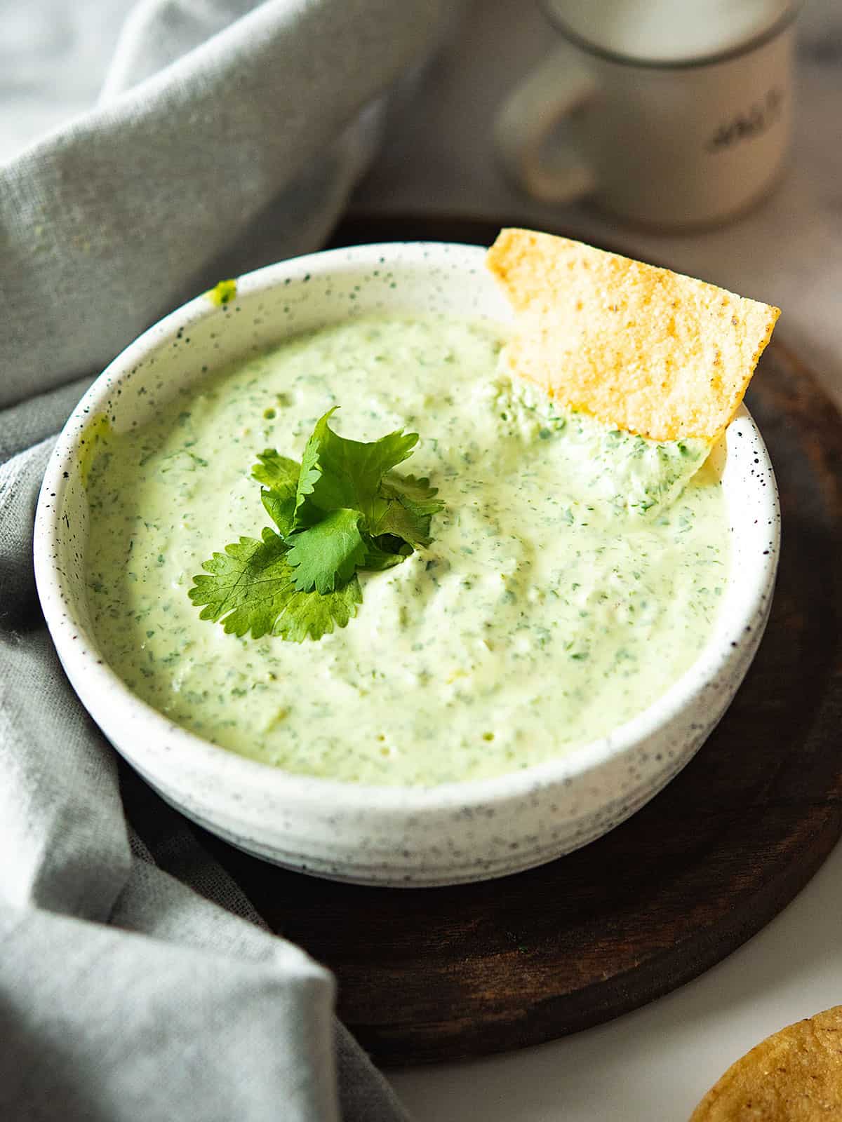 Delicious jalapeno cilantro sauce in a bowl with fresh ingredients.