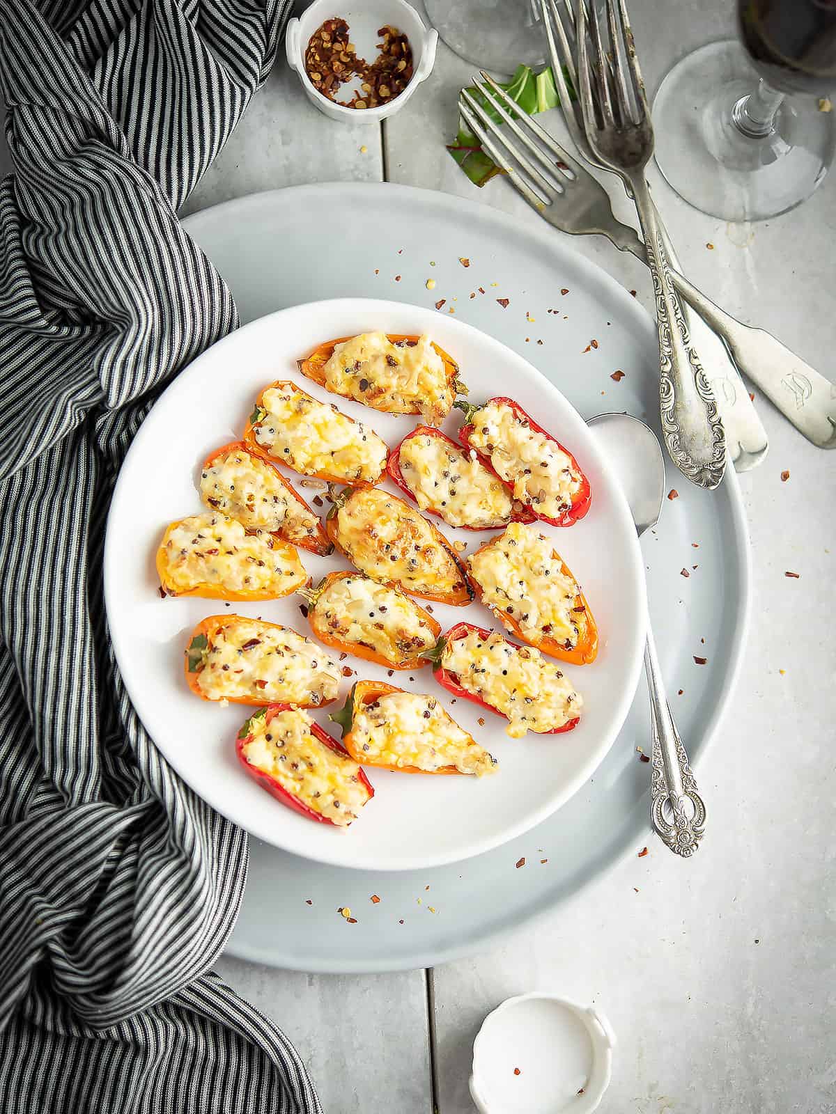 Cream cheese stuffed mini peppers on a platter, ready to serve.