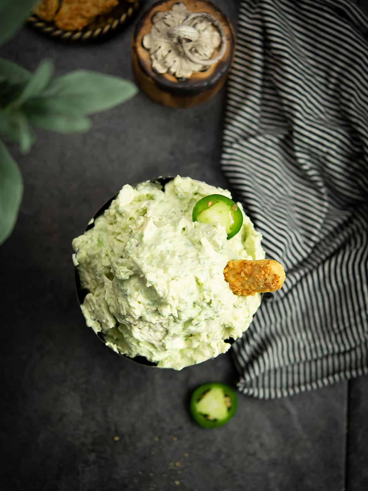 Creamy jalapeno cream cheese dip in a bowl with crackers