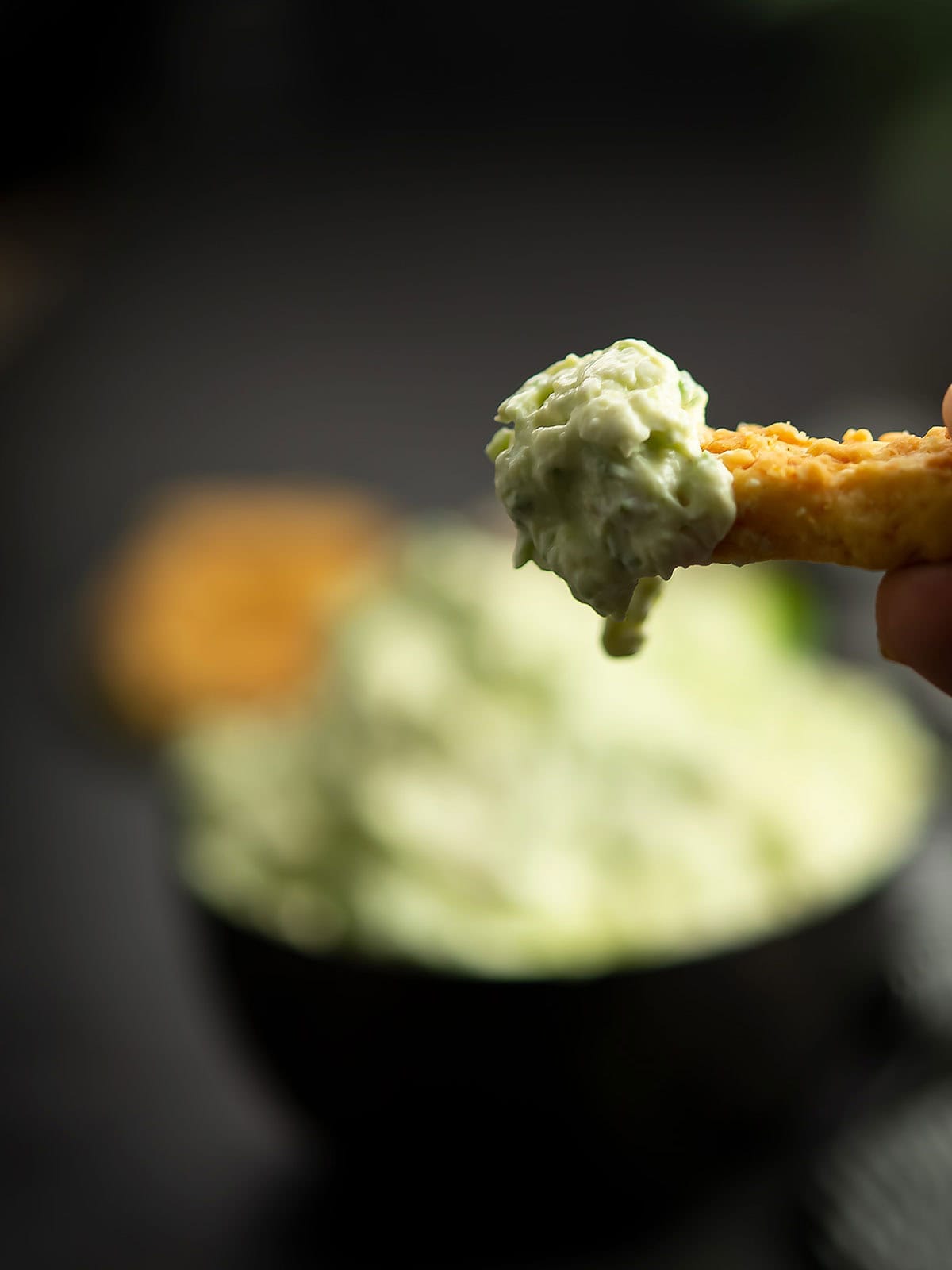 Close-up of spicy jalapeno cream cheese dip served with crackers.