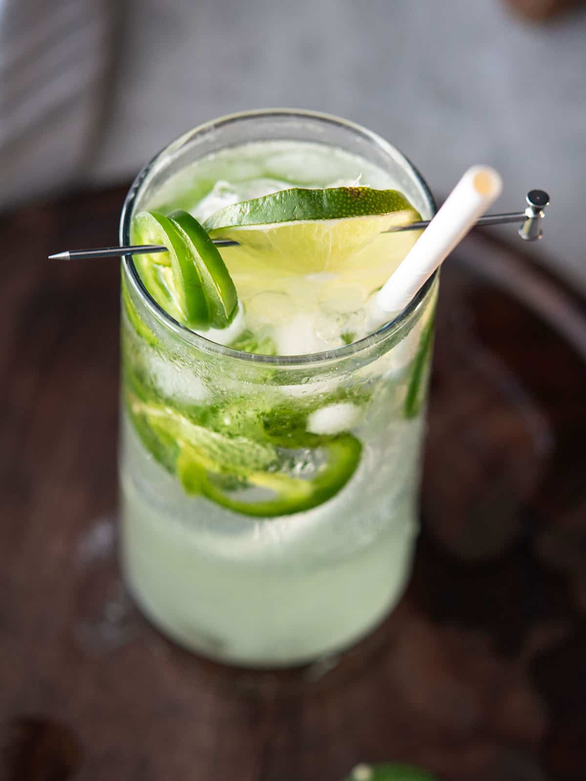 serving mojito with lime slices and straw