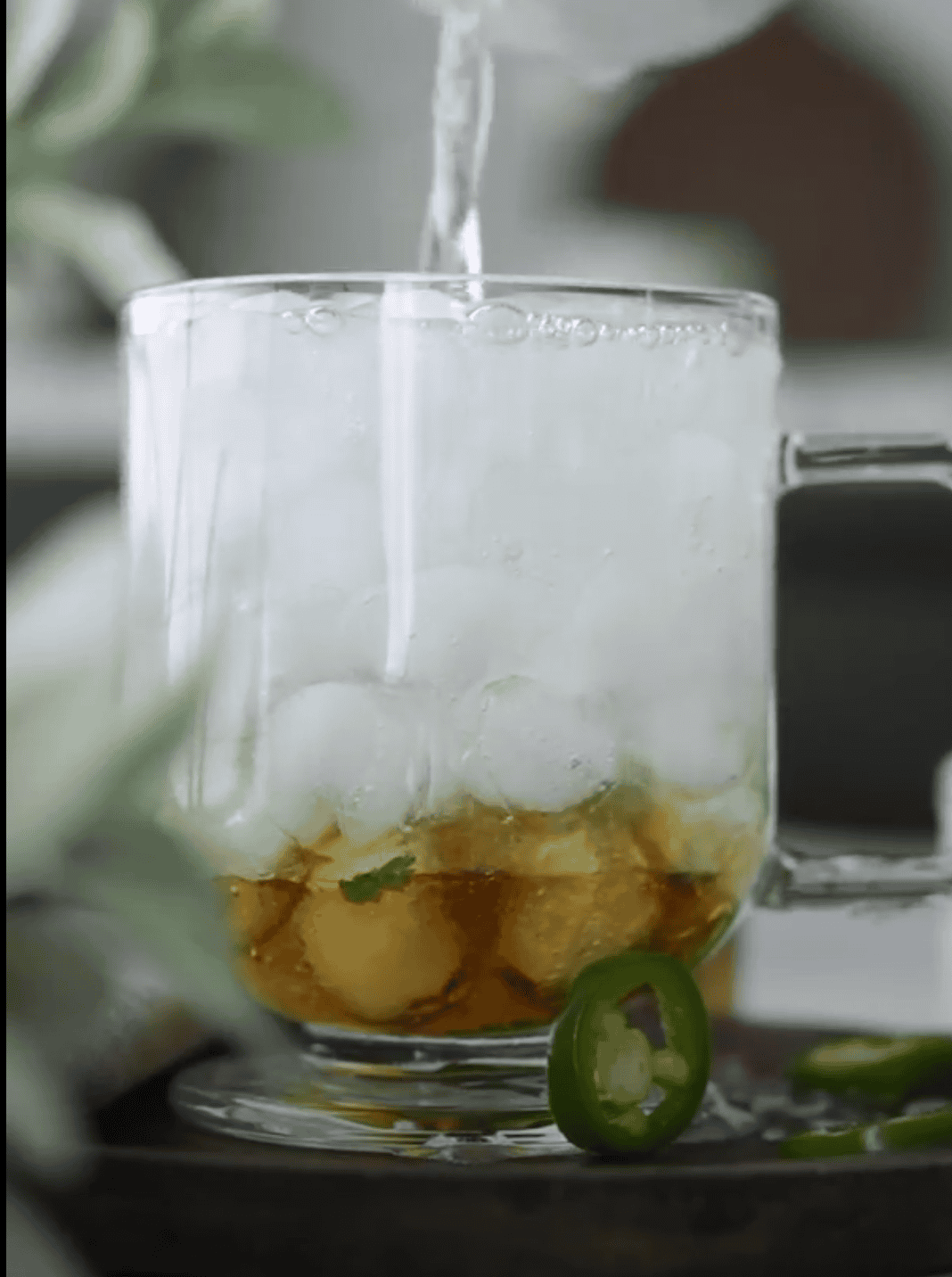adding sparkling water to make jalapeno mojito