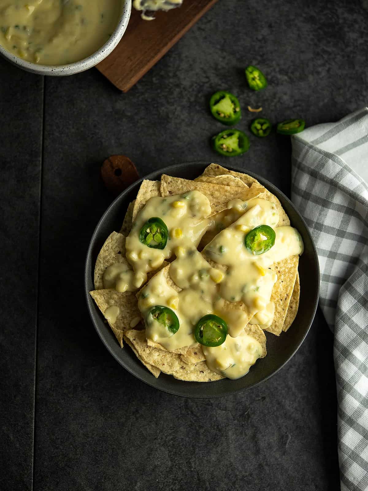 Delicious jalapeno nachos topped with creamy cheese and fresh jalapeno slices