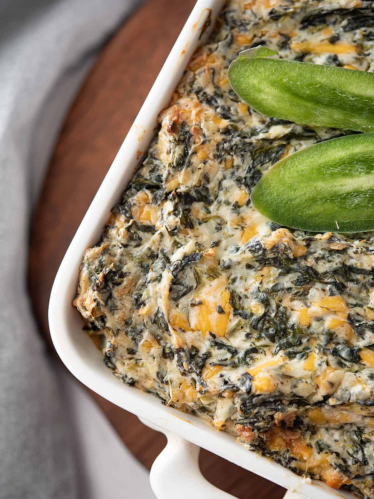Close-up of creamy jalapeno spinach dip with a golden-brown top.