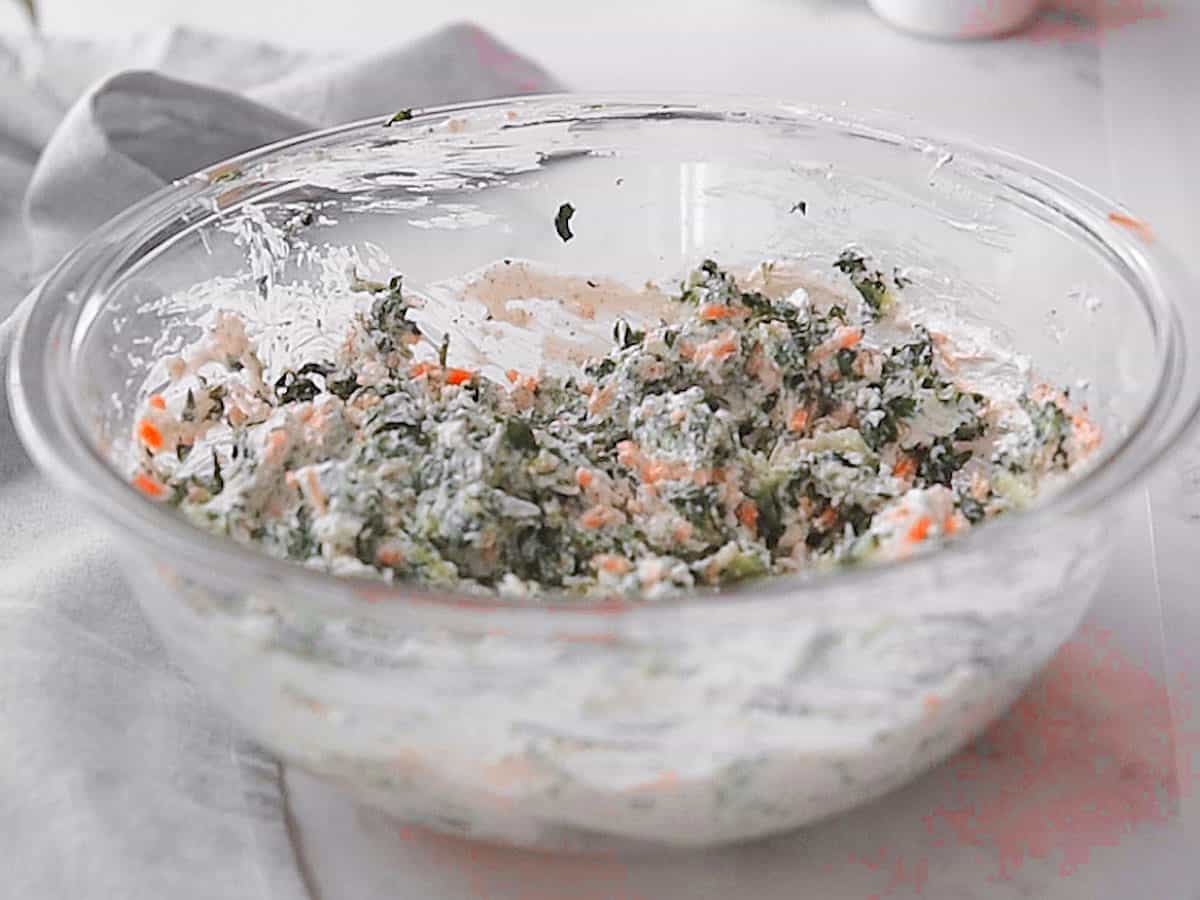 Mixing all the ingredients together for making jalapeno spinach dip