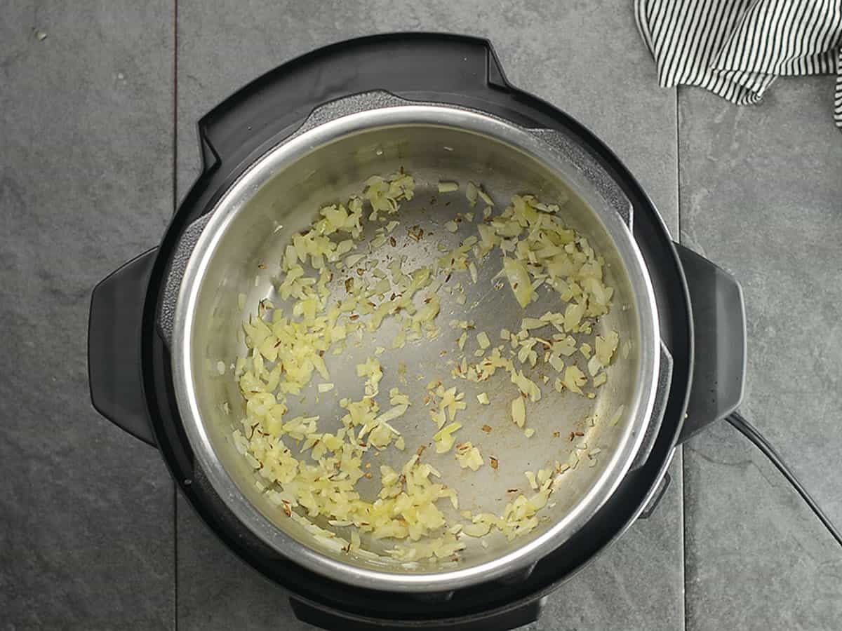 Sautéed onions and spices in a pot for mung bean curry
