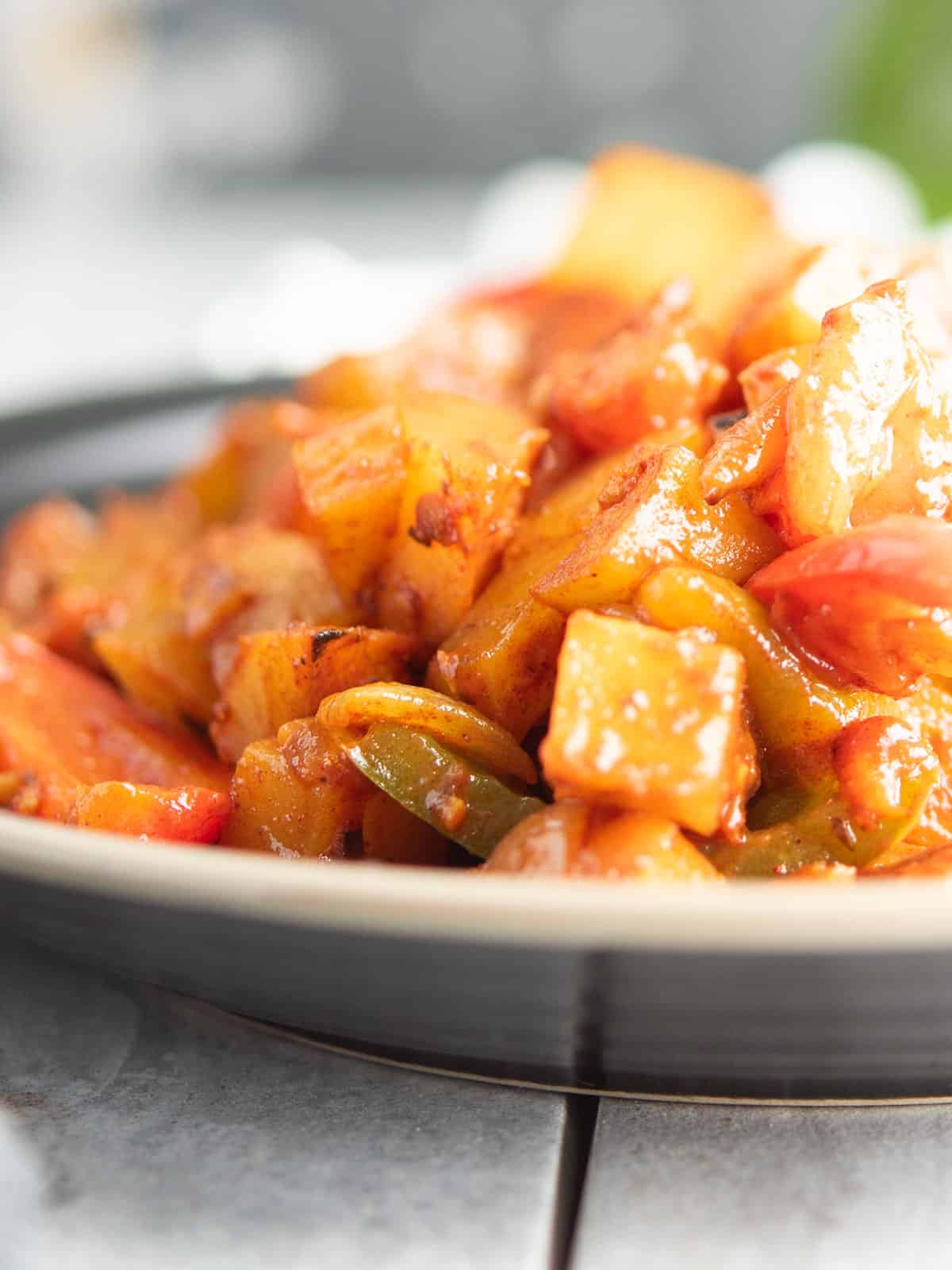 Close-up of Pepperonata showcasing the vibrant colors of peppers and tomatoes.