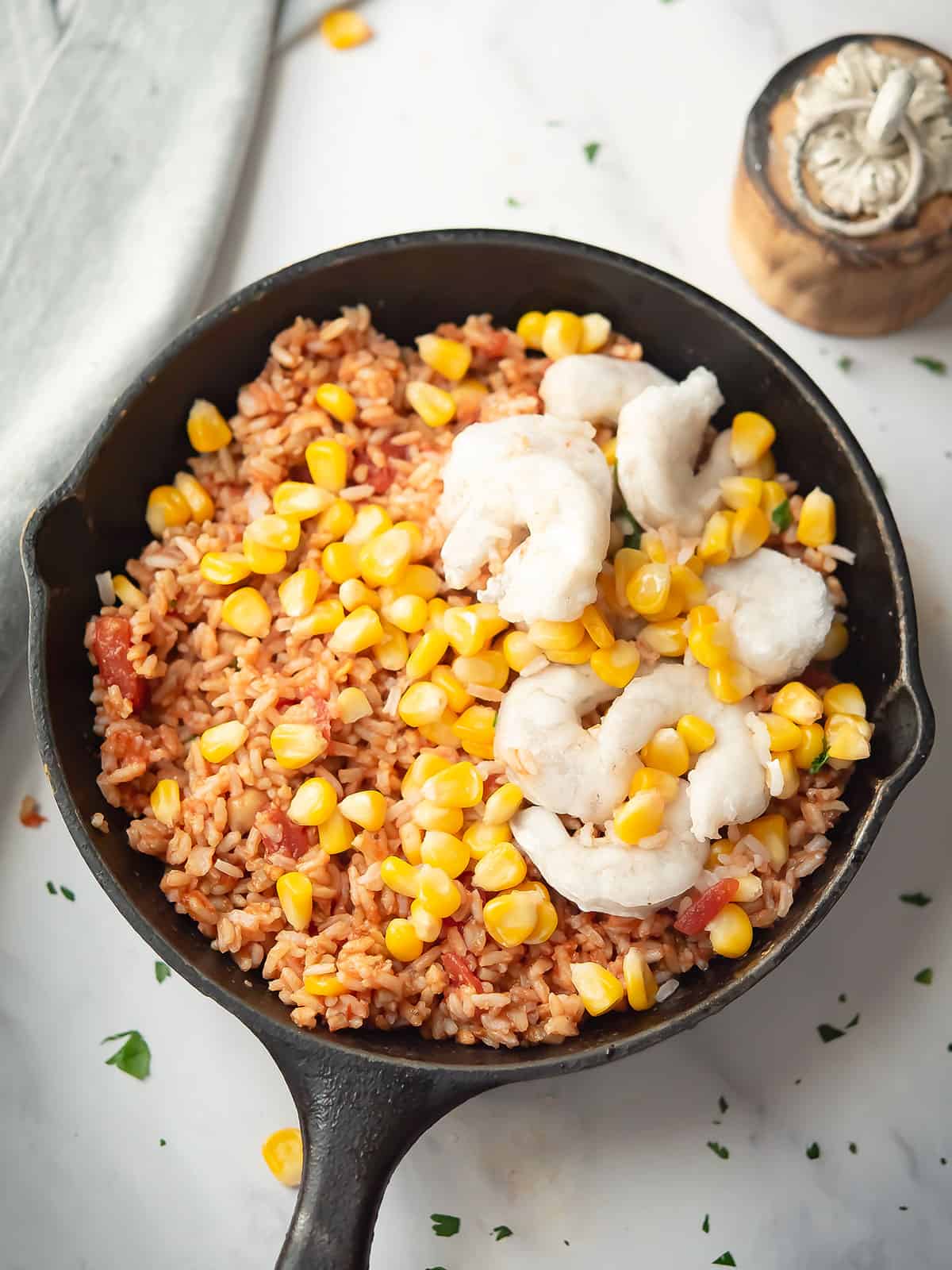 Cooking seafood and corn mixture in a pan