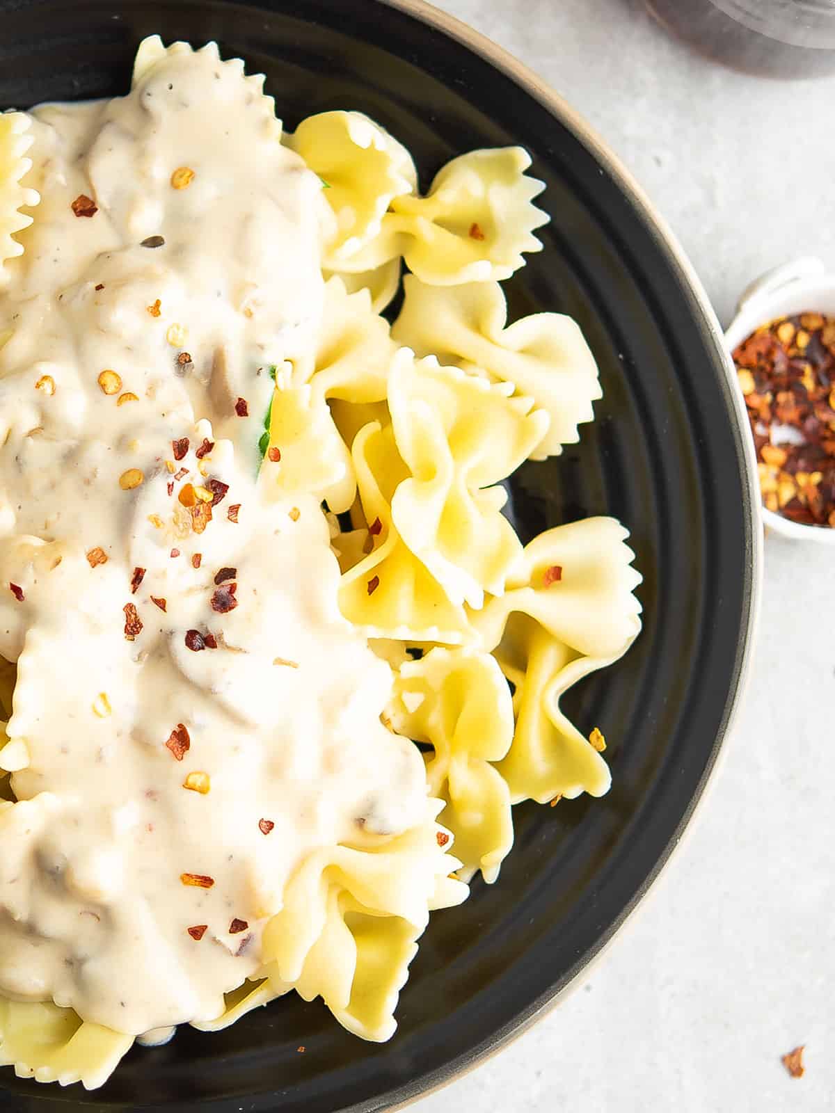 Creamy Spicy Alfredo Pasta Sauce served with pasta.