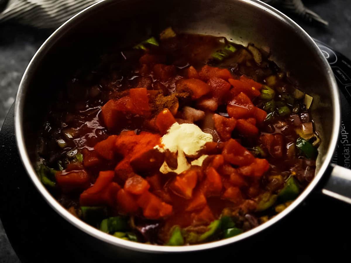 adding tomatoes to the base sauce