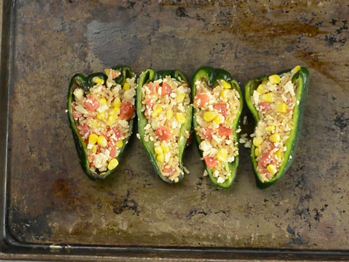 Stuffed peppers arranged in a baking dish ready for the oven.