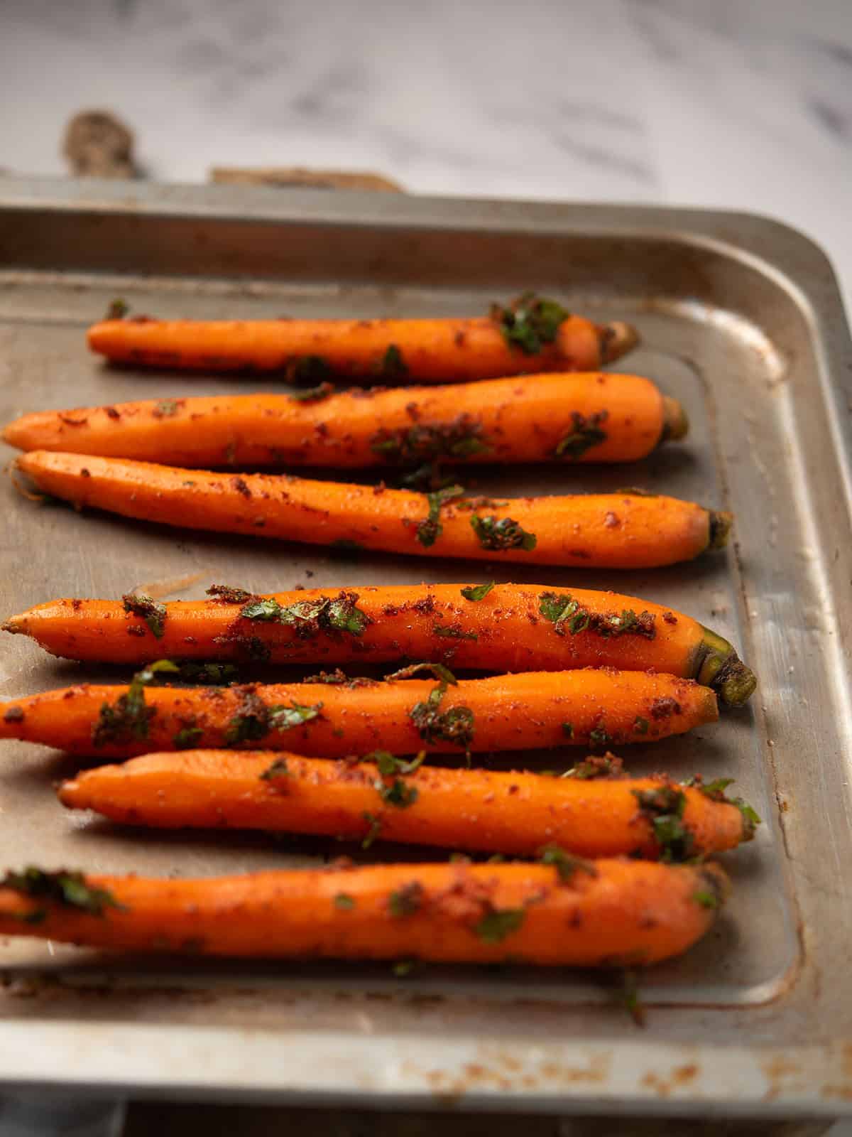 Evenly spread carrots on a baking sheet lined with parchment paper
