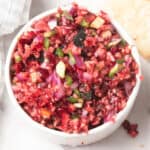 cranberry jalapeno salsa in a white bowl with chips