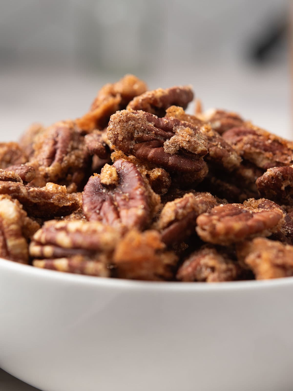 Close-up of crunchy spicy candied pecans on a plate.