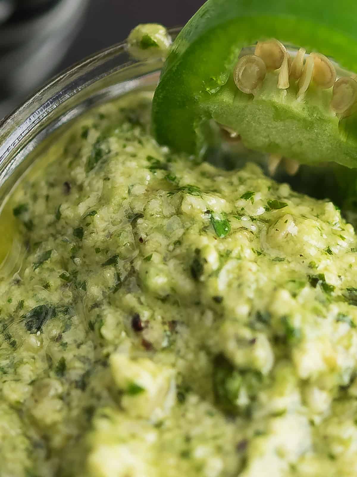 Close-up of creamy jalapeno pesto with fresh ingredients.