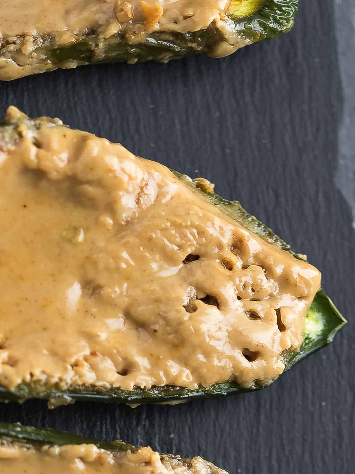 Close-up of peanut butter stuffed jalapenos with a creamy finish