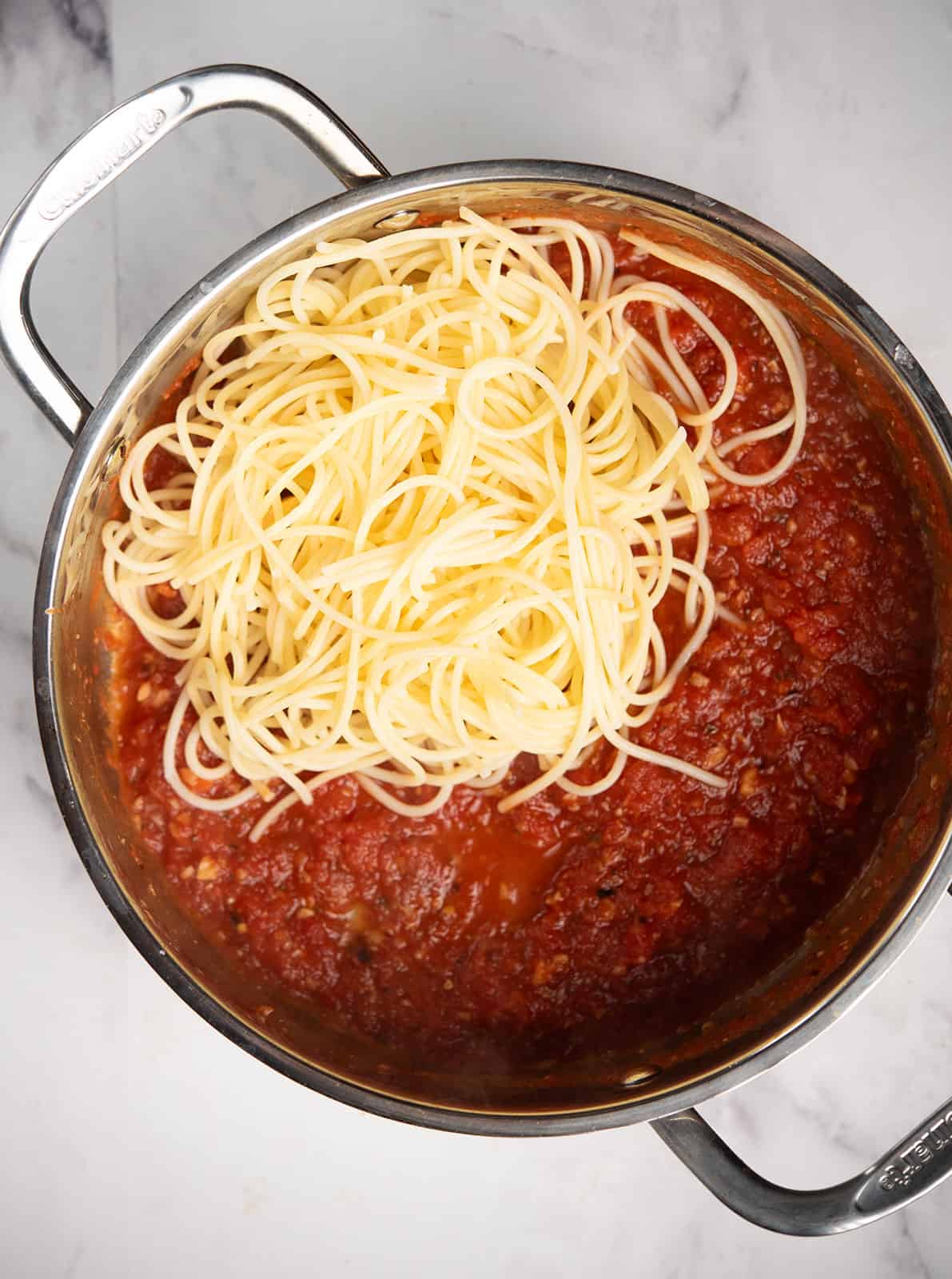 Cooked spaghetti tossed in spicy tomato sauce.