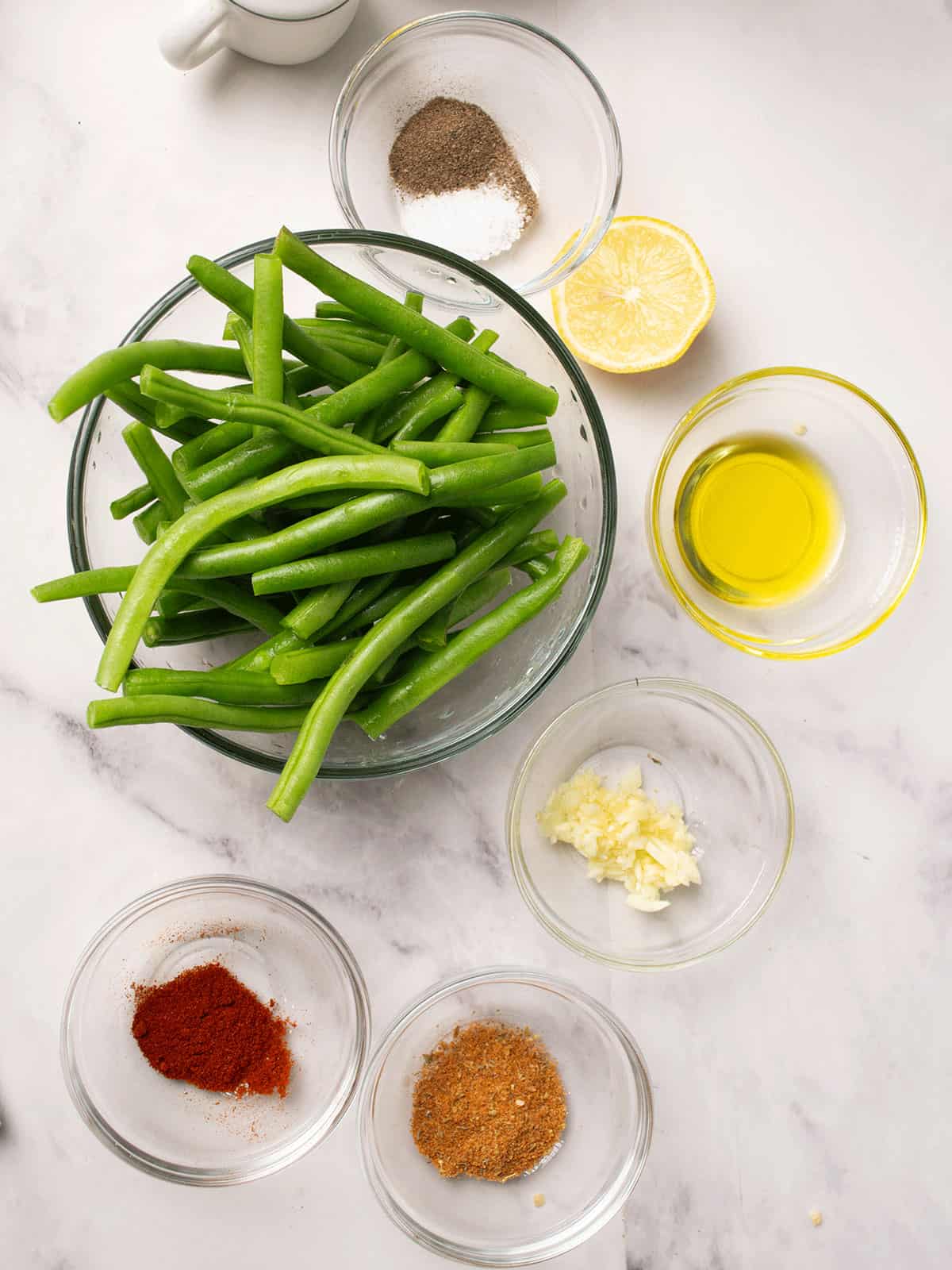 ingredients of the cajun green beans arranged in a kitchen counter