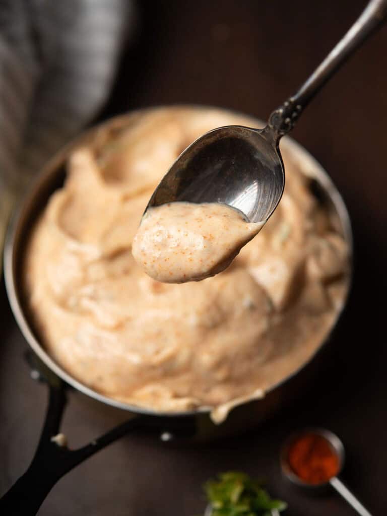 Delicious bowl of homemade Chili Aioli dip with a vibrant color.