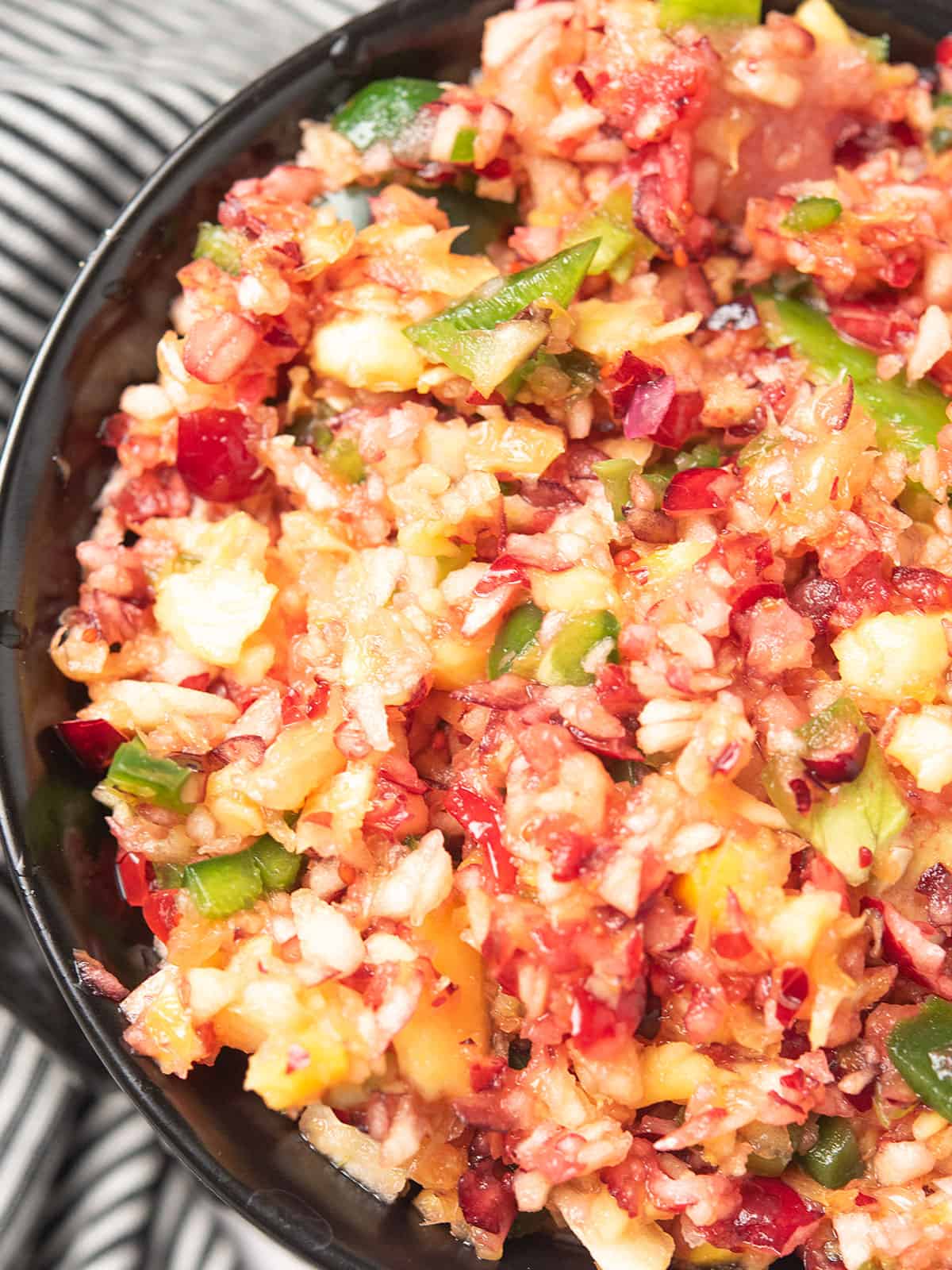 Close-up of cranberry jalapeño relish showcasing vibrant colors and chunky texture.