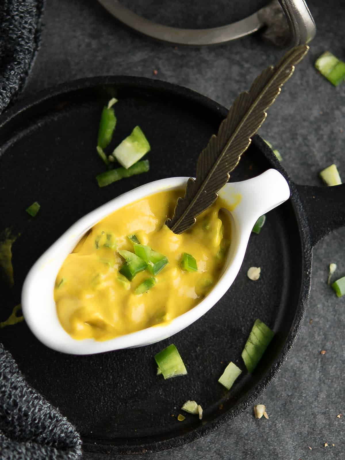 jalapeno mustard placed over the dining table with a spoon