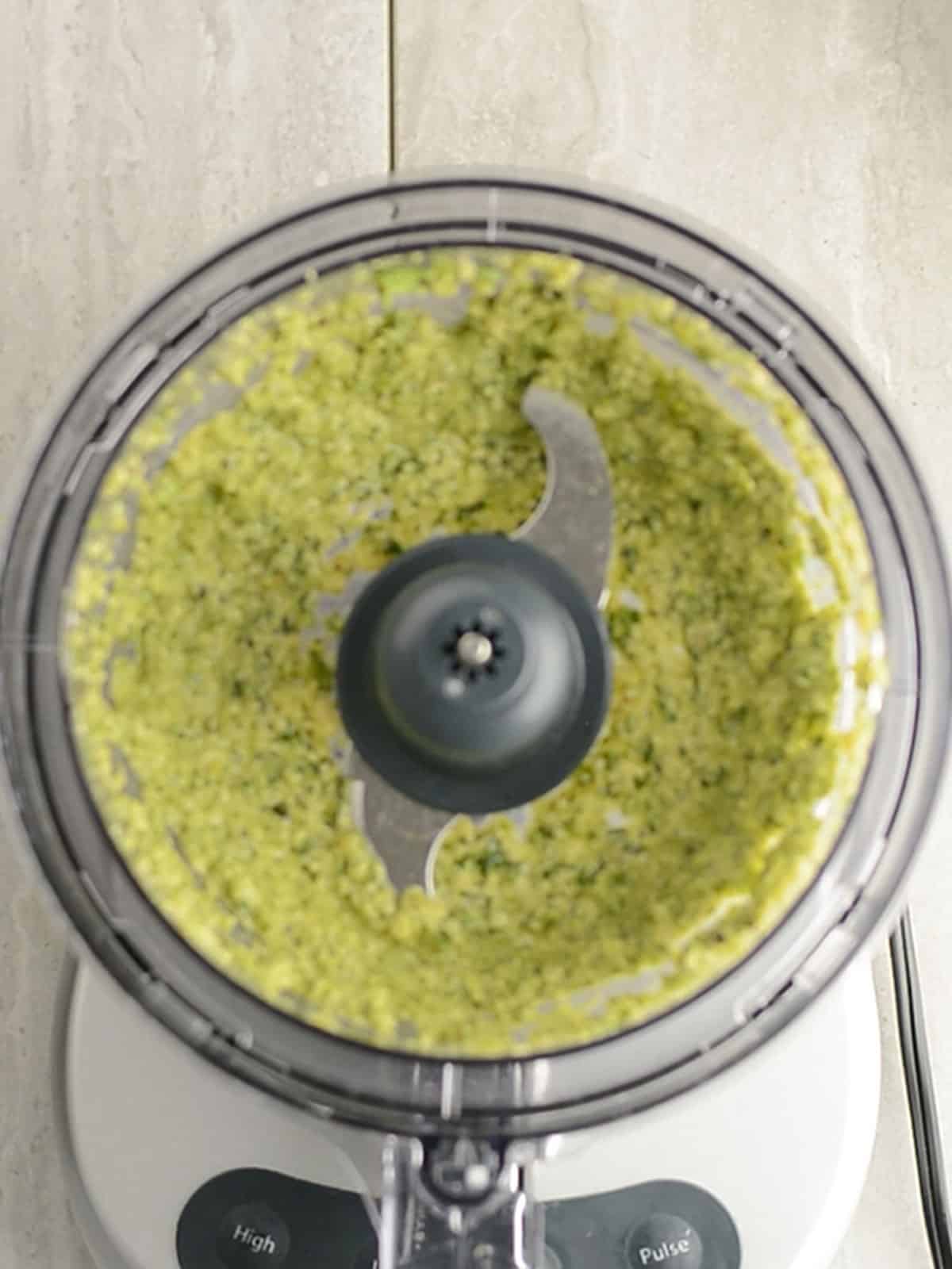Blending ingredients for jalapeno pesto in a food processor.