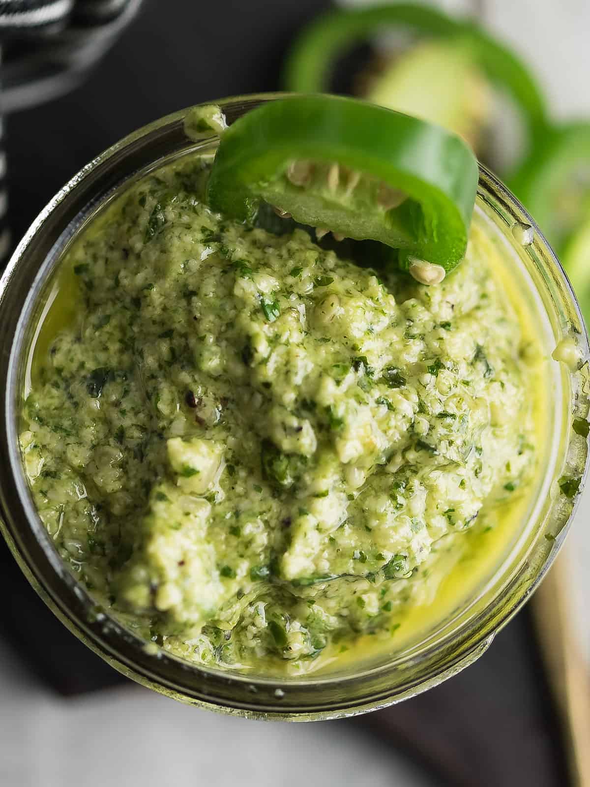 Bowl of vibrant green jalapeno pesto sauce