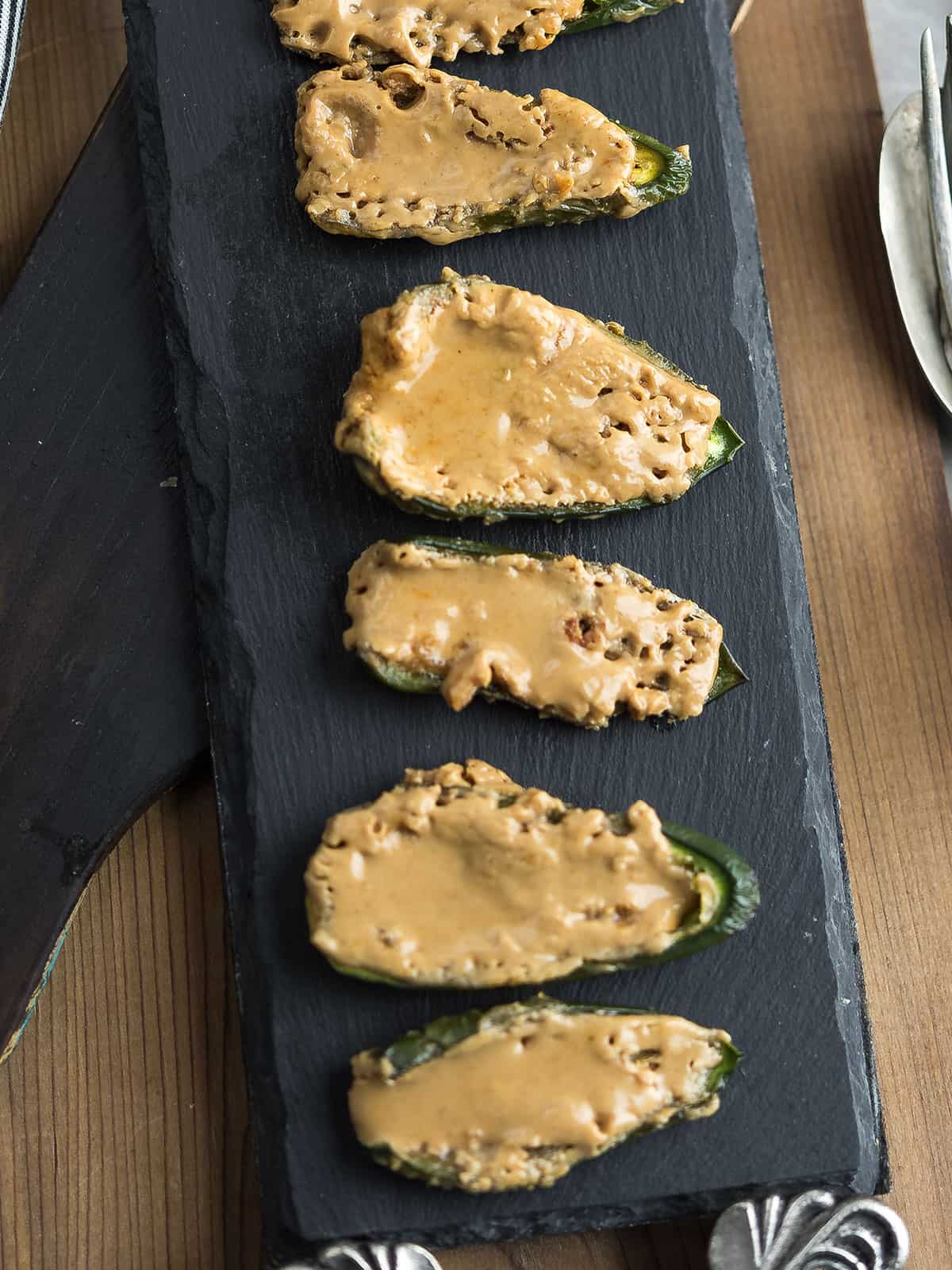 Delicious peanut butter stuffed jalapenos on a serving board