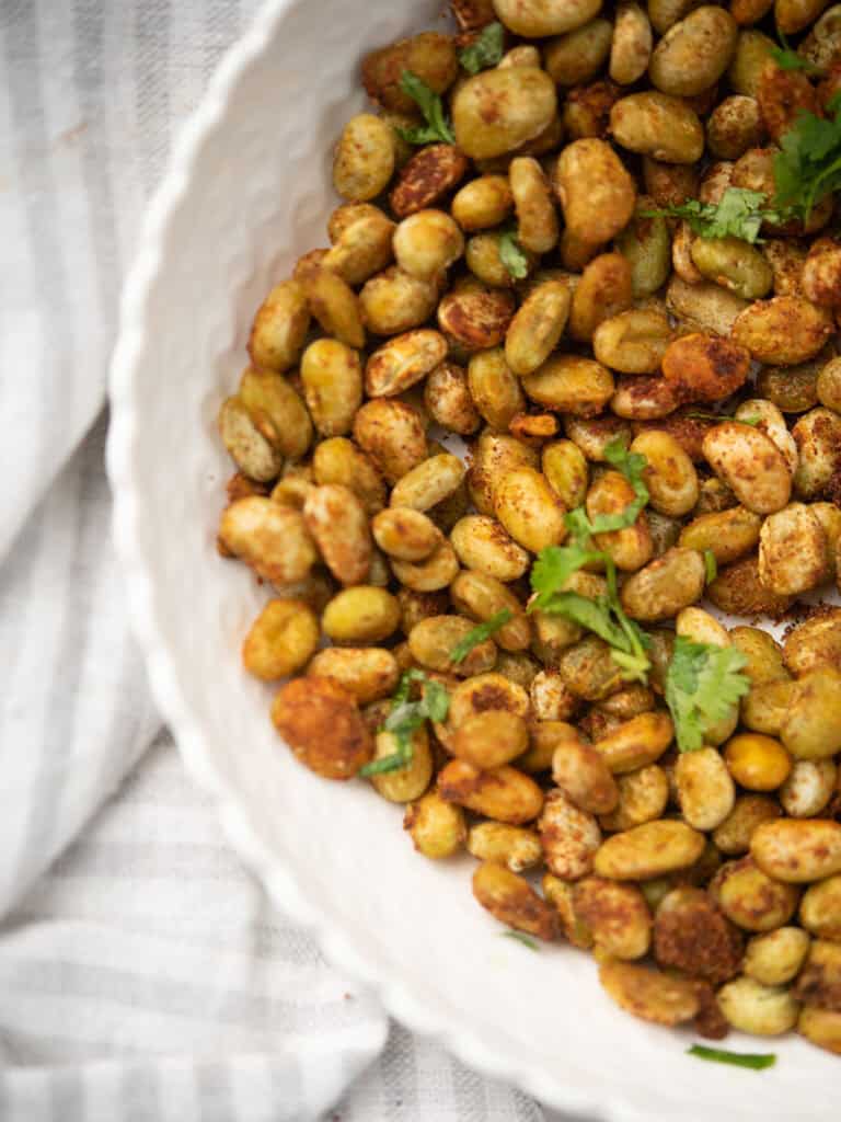 Freshly roasted lima beans garnished with parsley, served warm.