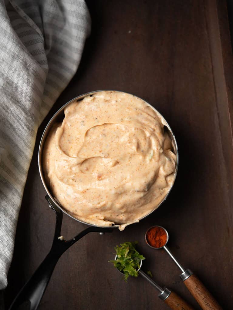 Chili Aioli served for dipping fresh vegetables and pita chips over the dining table