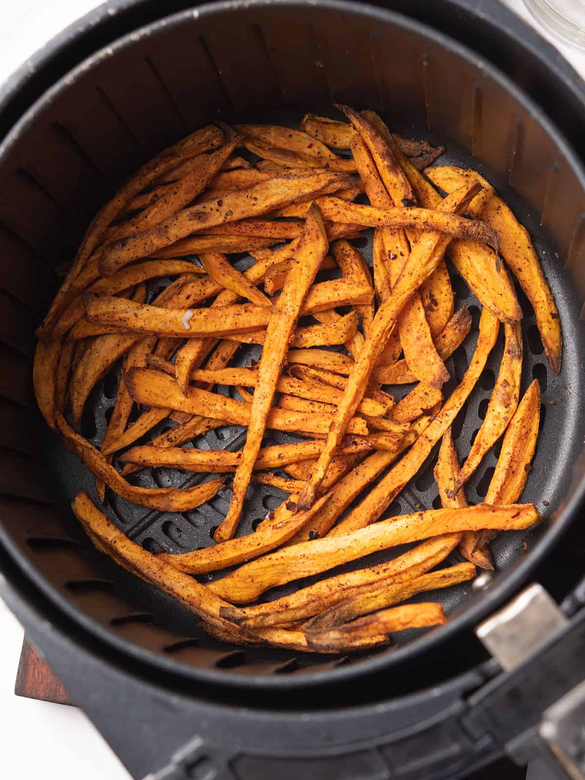 Cooked spicy sweet potato fries fresh out of the air fryer.