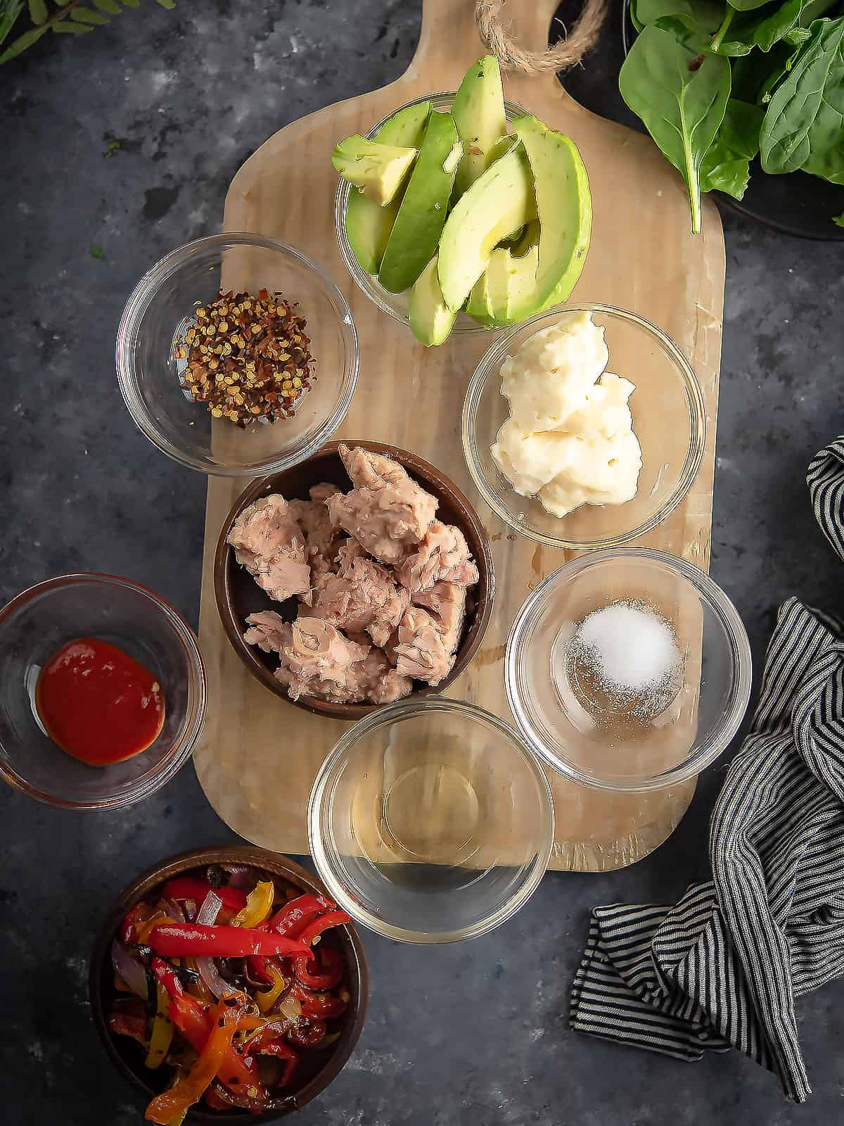 Ingredients are assembled in small cups over the counter top.