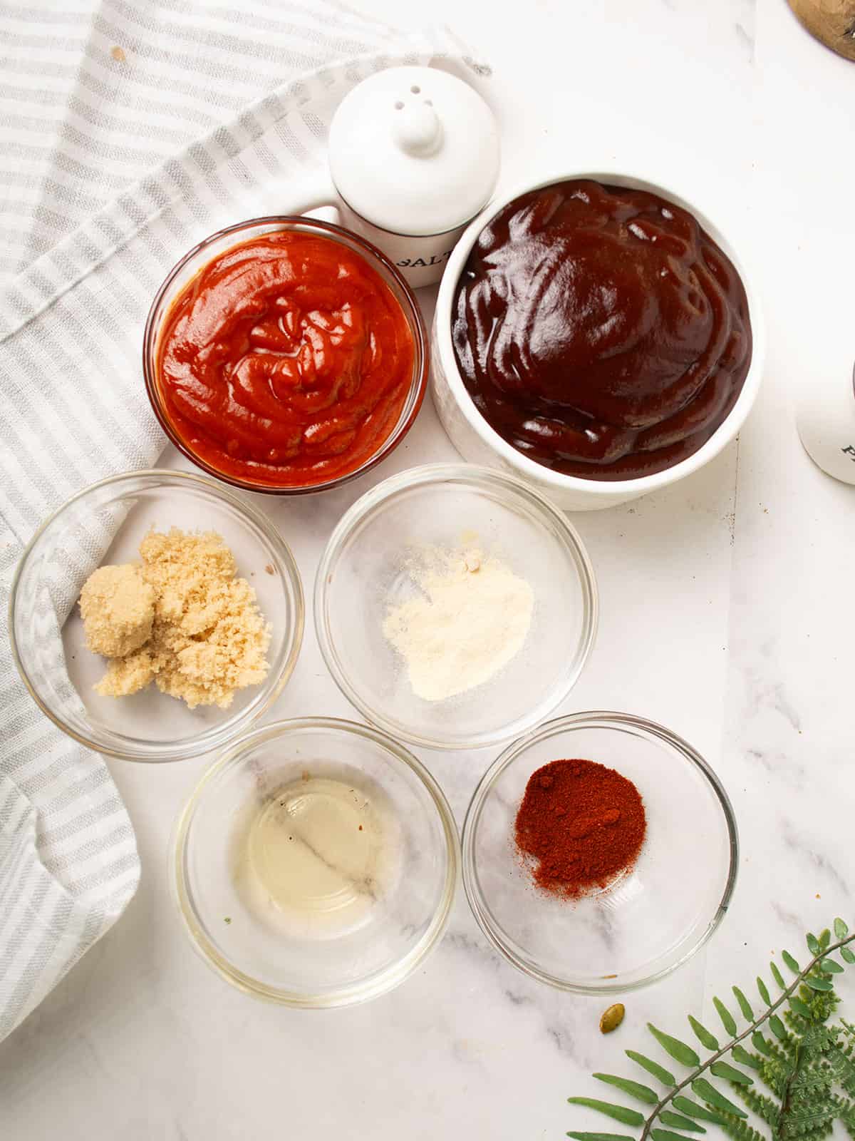Ingredients for Sriracha BBQ Sauce on a kitchen counter.