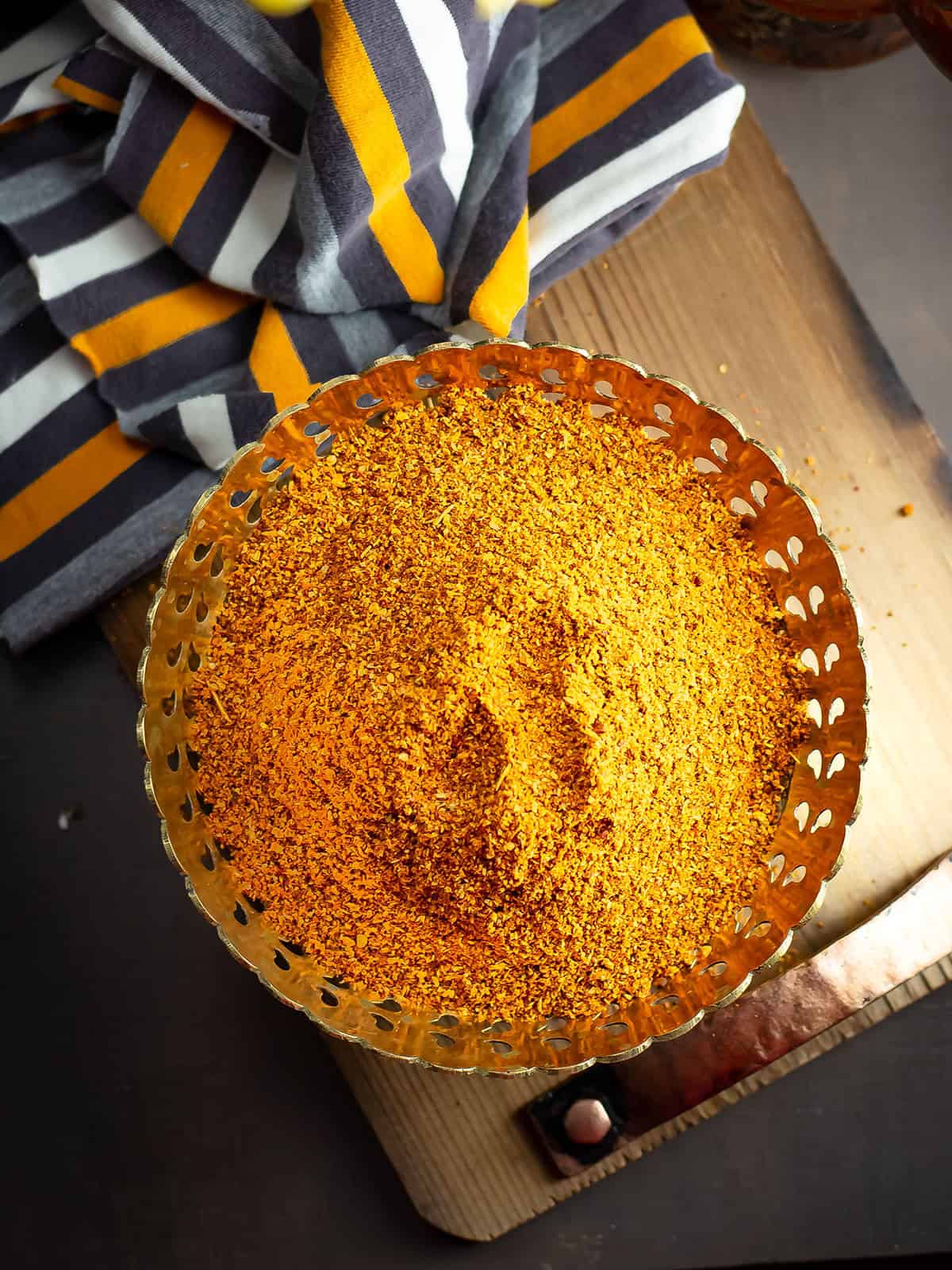 a bowl filled with Madras curry powder placed over kitchen counter