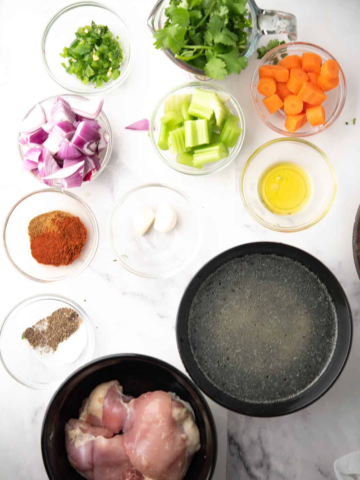 Ingredients for Cilantro Chicken Soup including chicken, broth, vegetables, and spices.