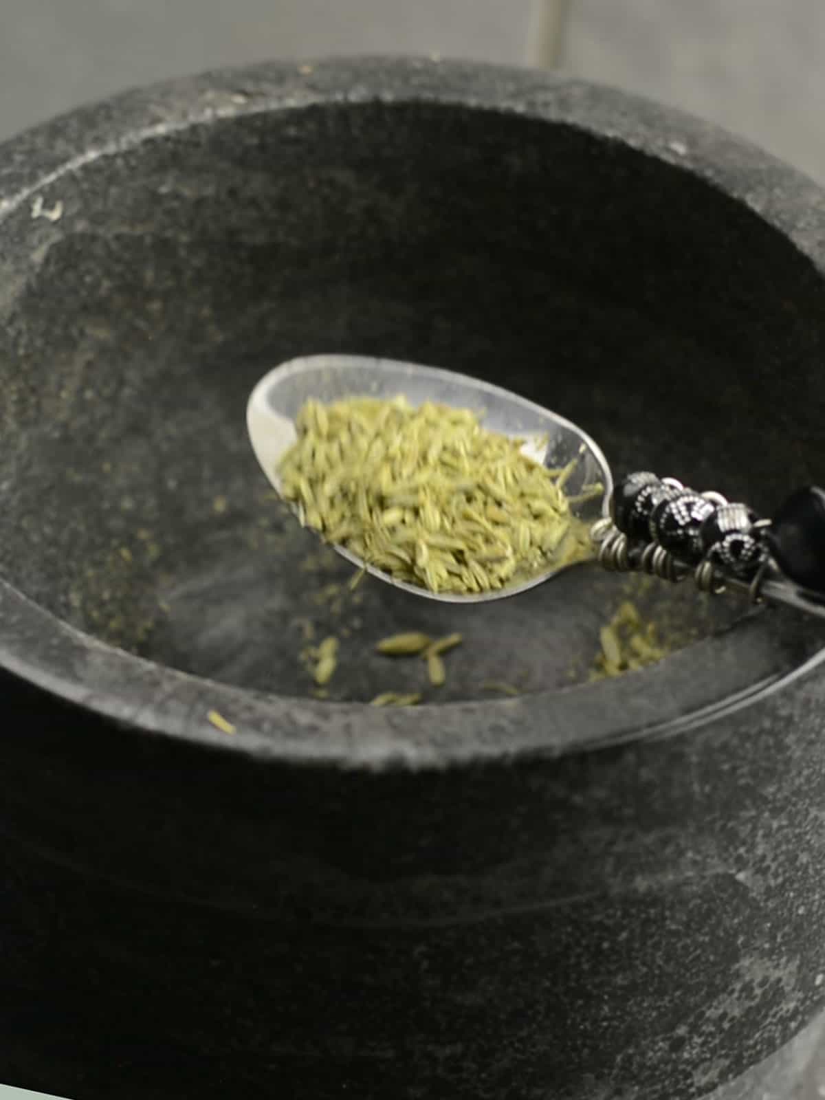 adding fennel to pestle and mortar