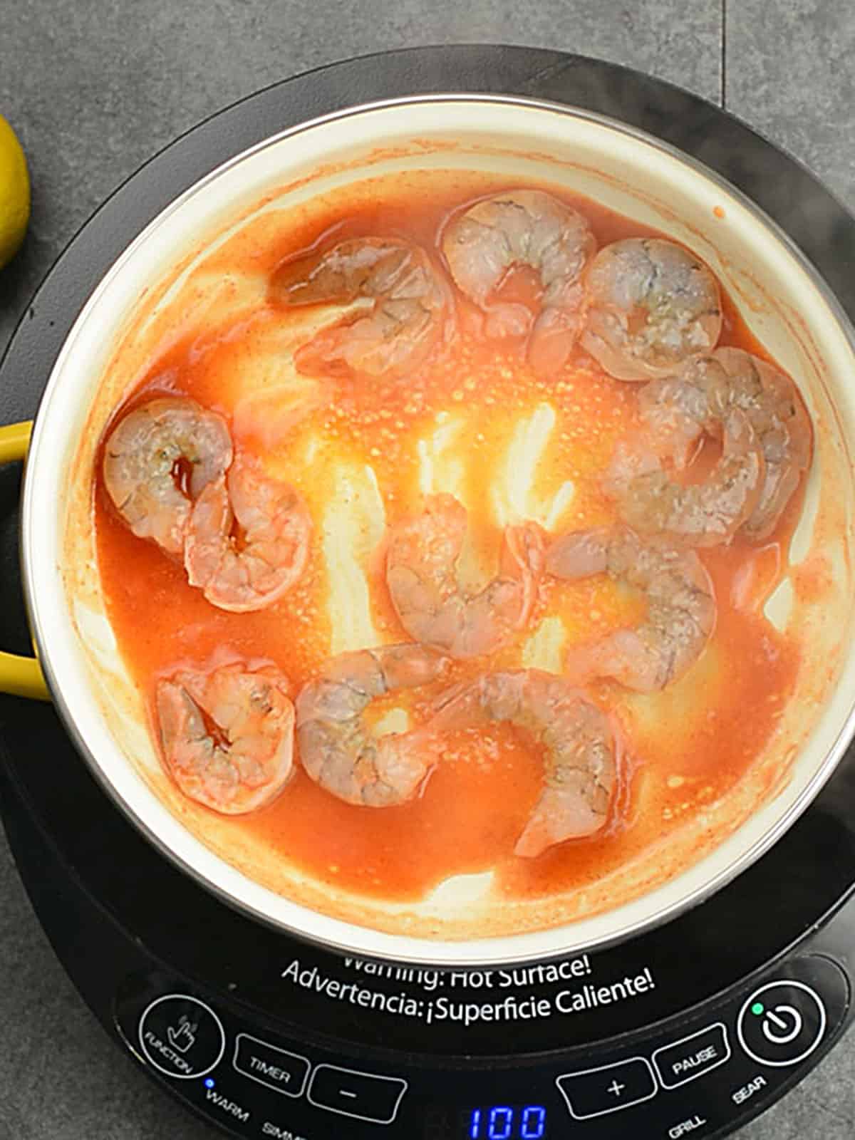 stirring the shrimp in the sauce