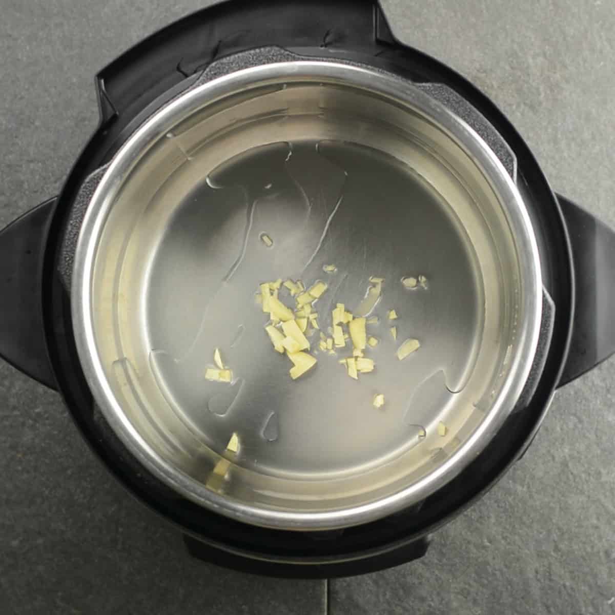 Sautéing minced garlic in olive oil in the Instant Pot.
