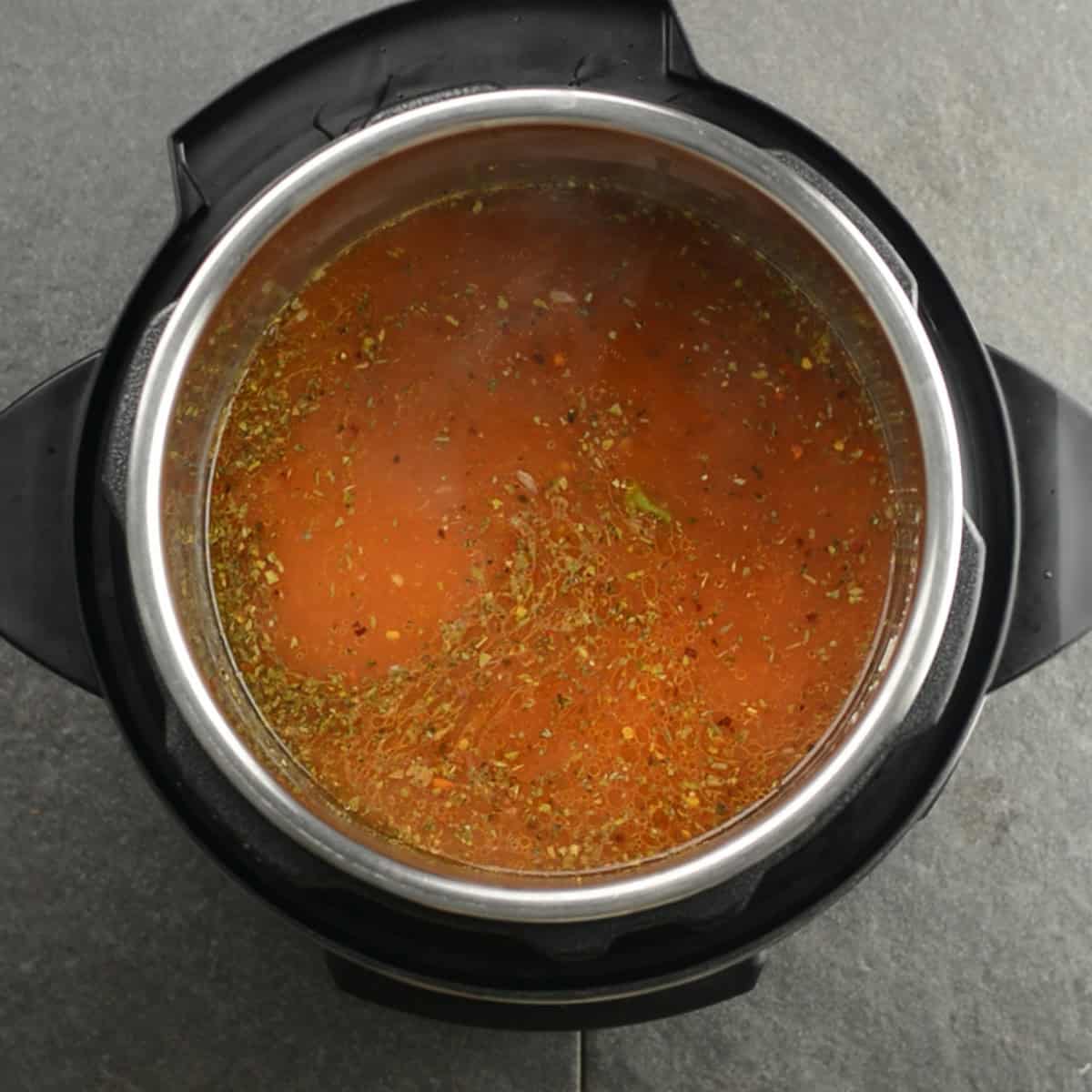 smixing all the ingredients for this Instant Pot penne pasta