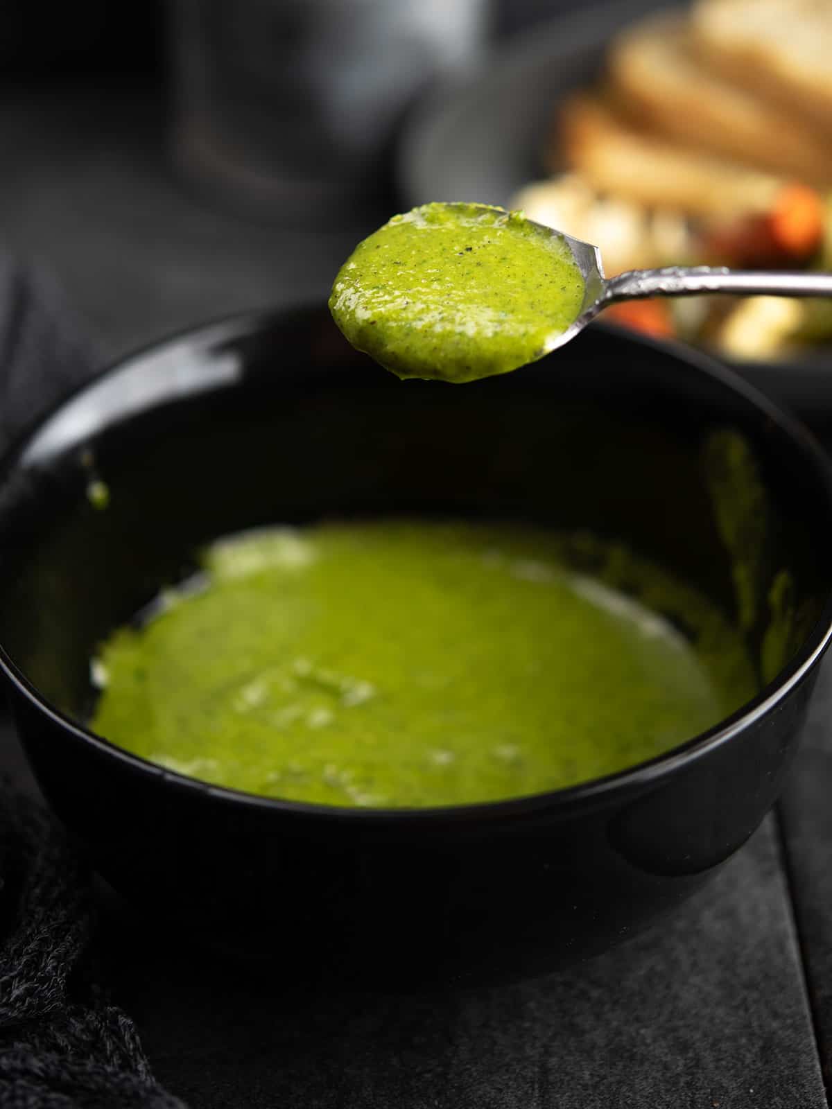jalapeno vinaigrette with the spoon in a green color